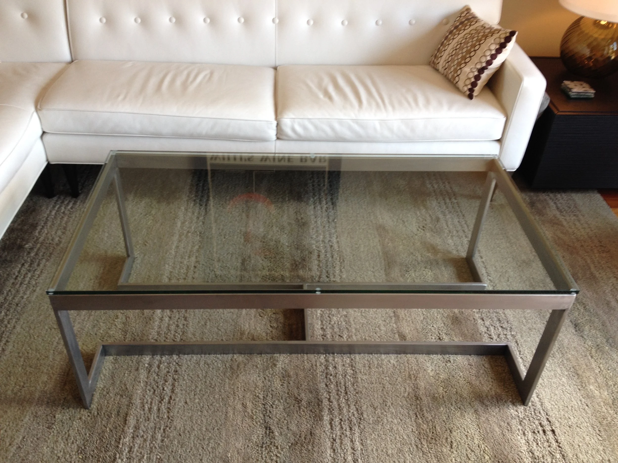   Modern Coffee Table   This table is made from mild steel rectangular tube, with 1/2" thick tempered-glass top. &nbsp;It's bare steel with a hand-grained finish. &nbsp;This table was custom-designed for a client in Mill Valley, Ca. 