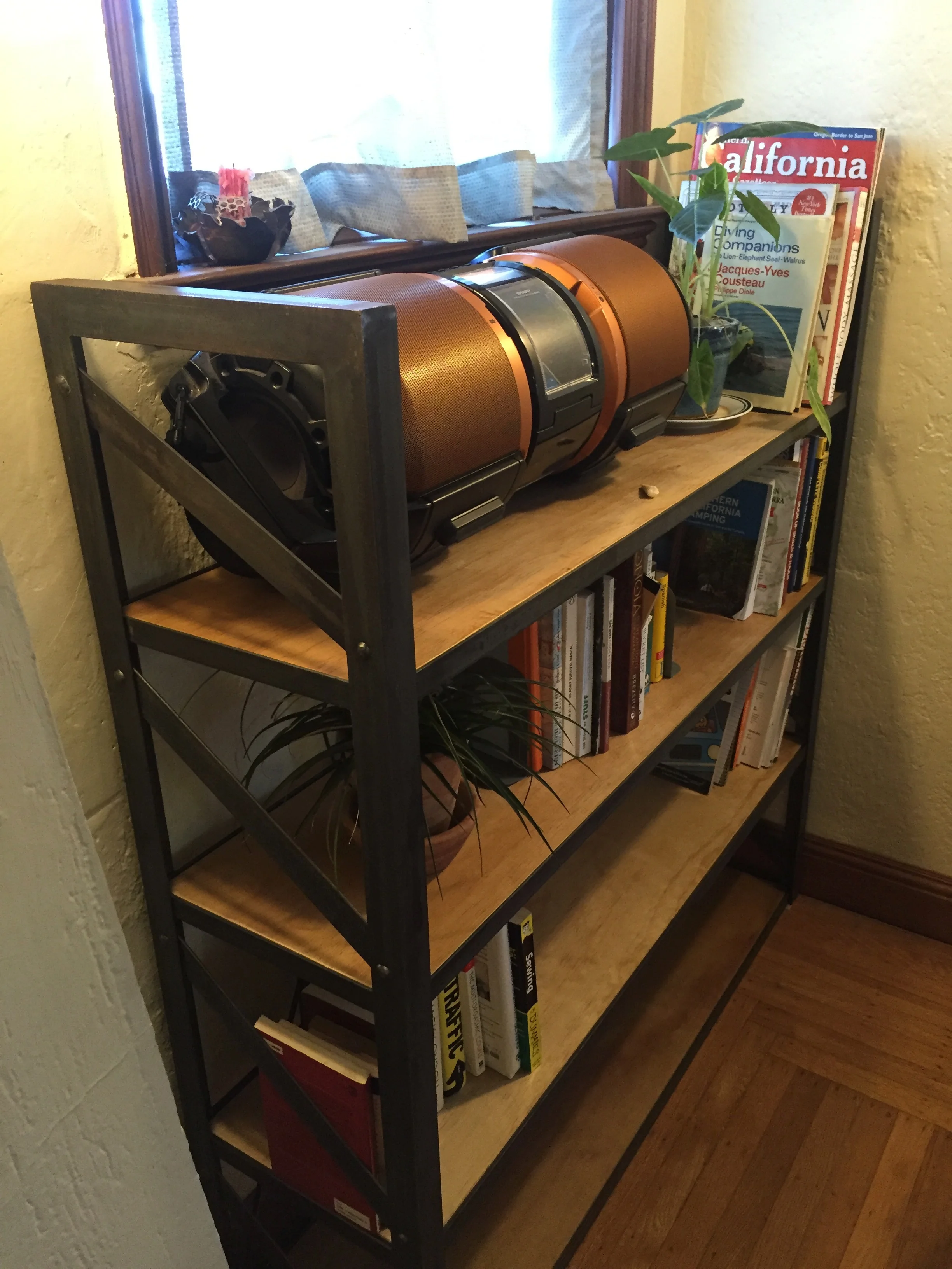   Industrial-Style Bookshelf   This sturdy bookshelf features handmade faux rivets and shelves of waxed maple wood. 