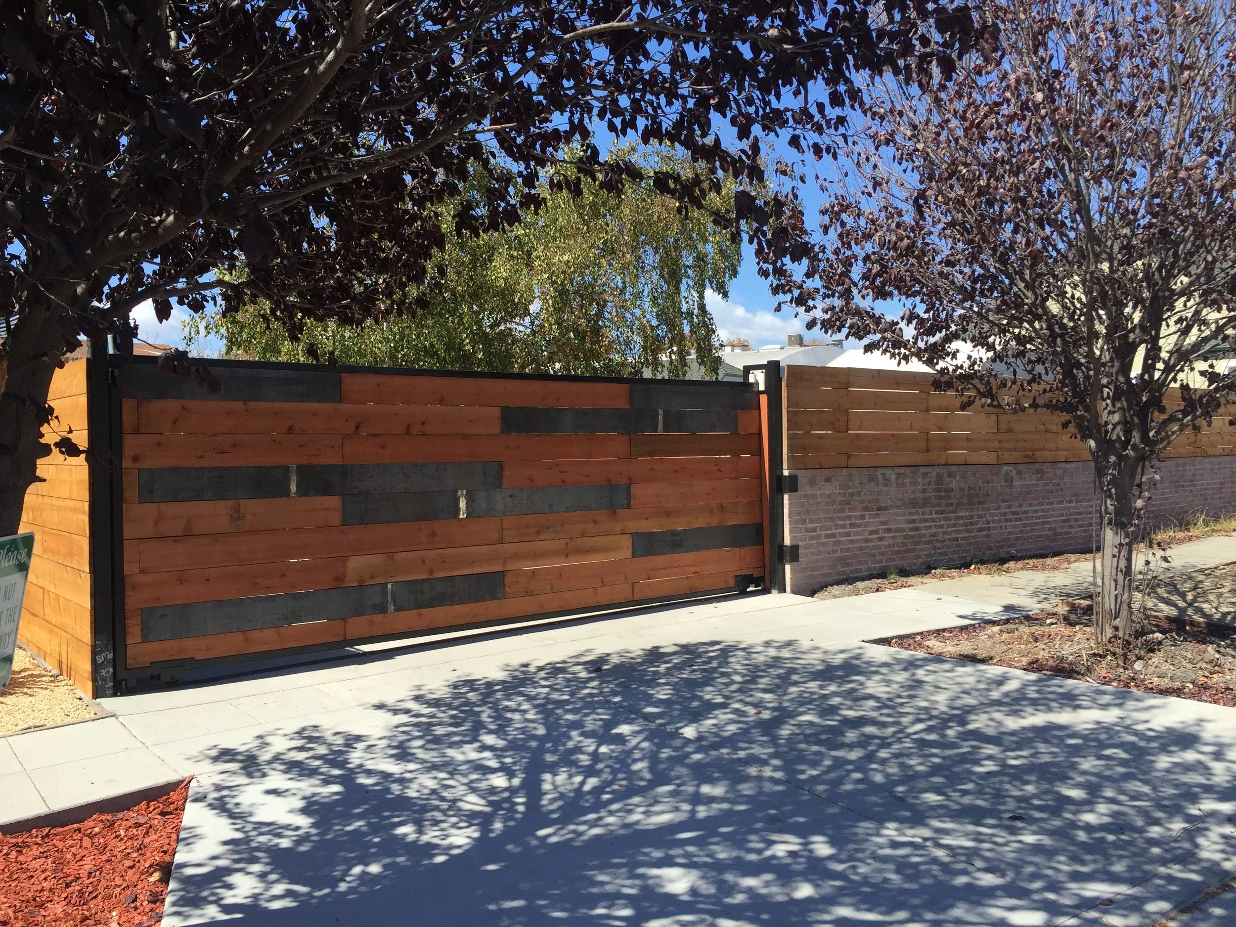  Corten Steel and redwood Driveway gate   This sliding driveway gate features Corten steel accents and an automatic opener. 