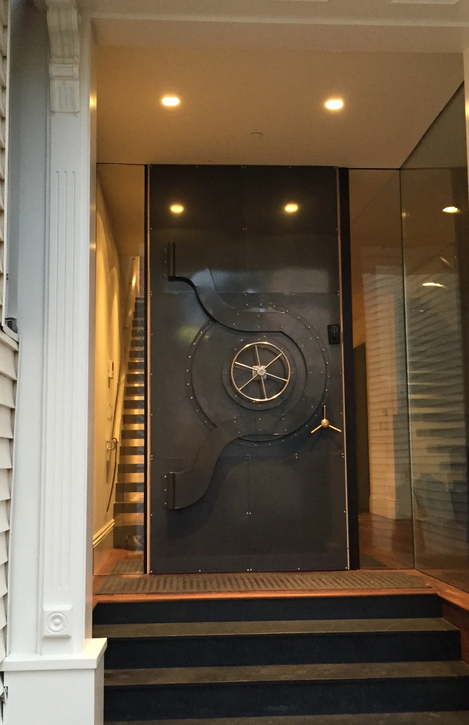   Bank Vault Front Door   This entry door is a one-of-a-kind, elegant conversation piece, modeled after the doors of classic bank vaults. Functional mechanical parts add a touch of whimsy to this North Beach developer’s showcase home.  The house was 