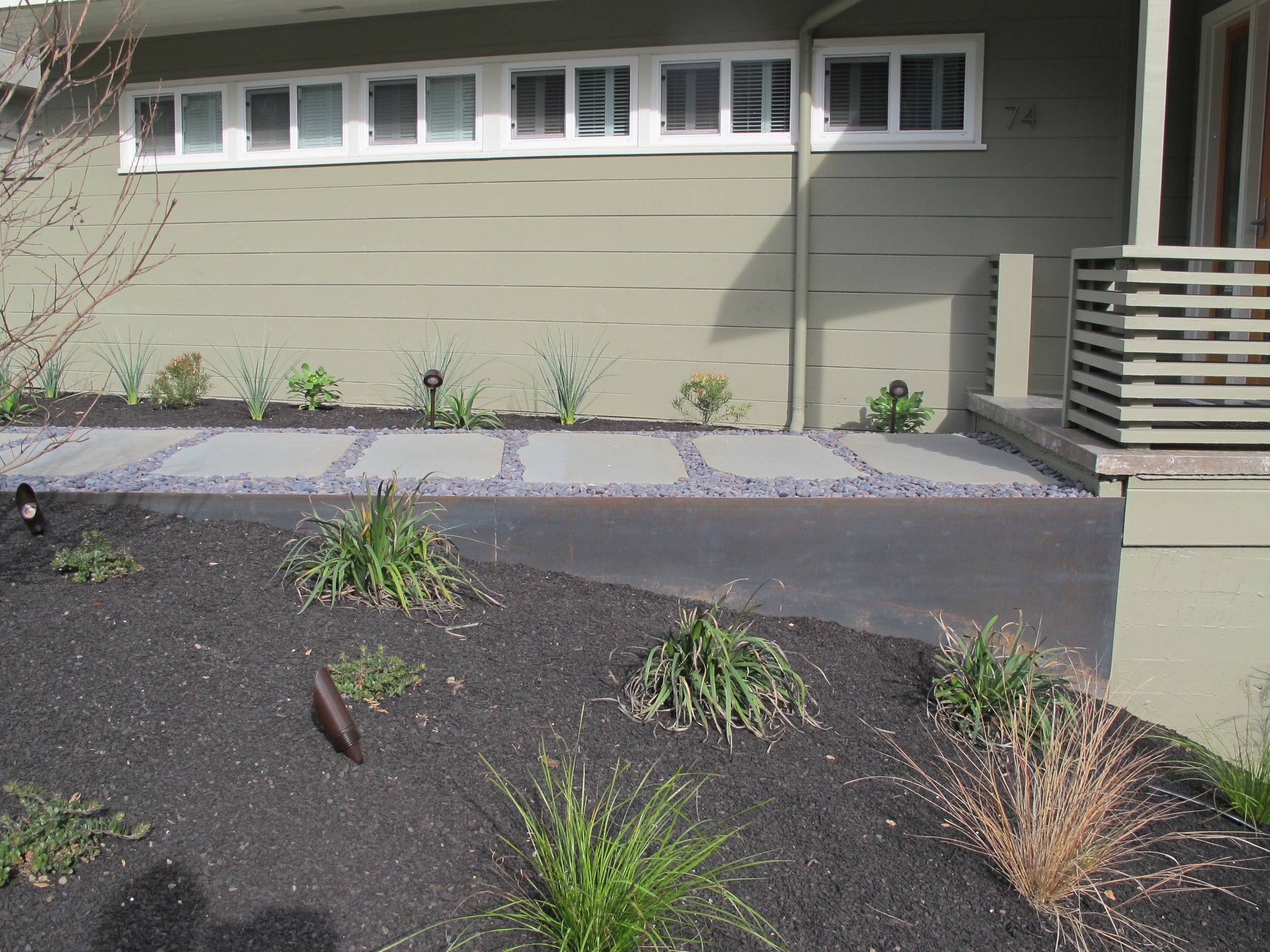   Cor-Ten Steel Retaining Wall   This retaining wall transformed an Oakland Hills&nbsp;client's front yard and driveway as part of a major landscape renovation. &nbsp;Made of Cor-Ten weathering steel, this piece was both decorative and functional. &n