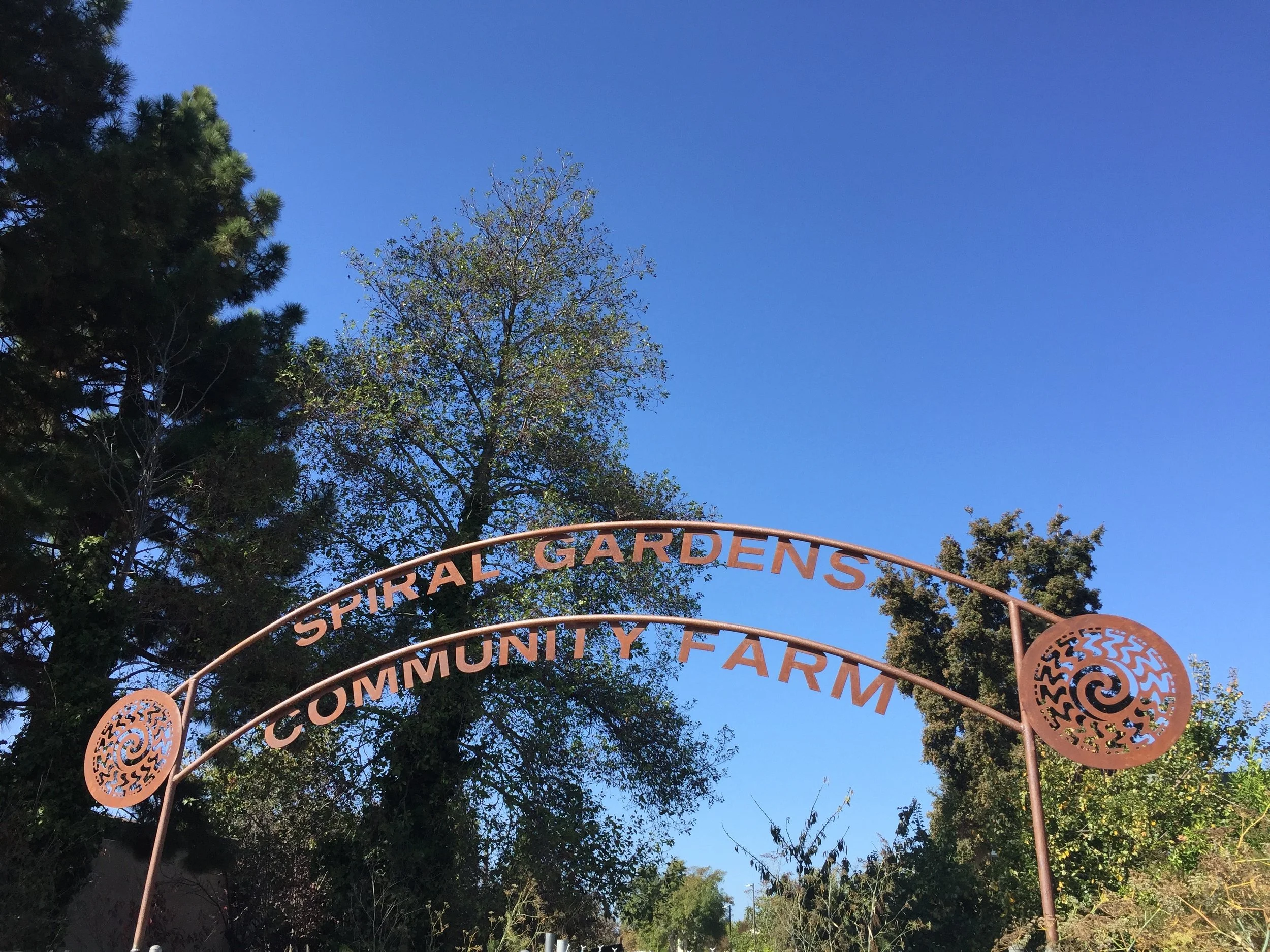   Spiral Gardens Gate Sign   This 12-foot-wide sign draws attention to an often-overlooked section of Spiral Gardens, a community garden in Berkeley. The CNC-cut lettering and logos are made from Cor-Ten weathering steel, giving this sign a rustic lo