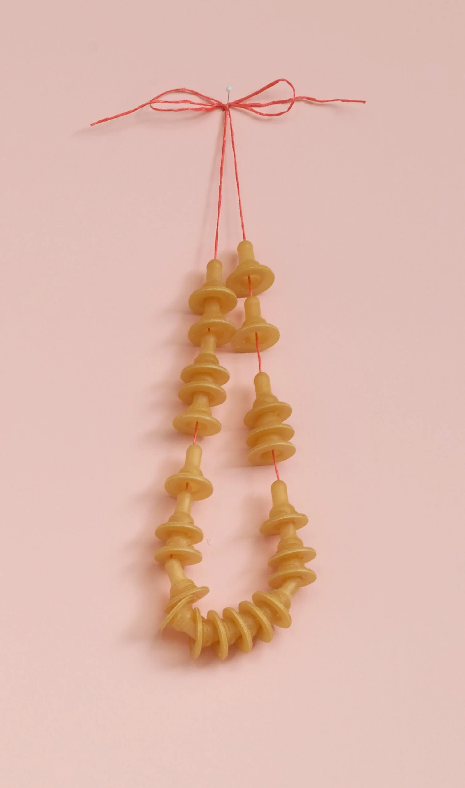 macaroni necklace, Craft twine and latex free nipples , Dims approx 5 X 18 inches, 2016.