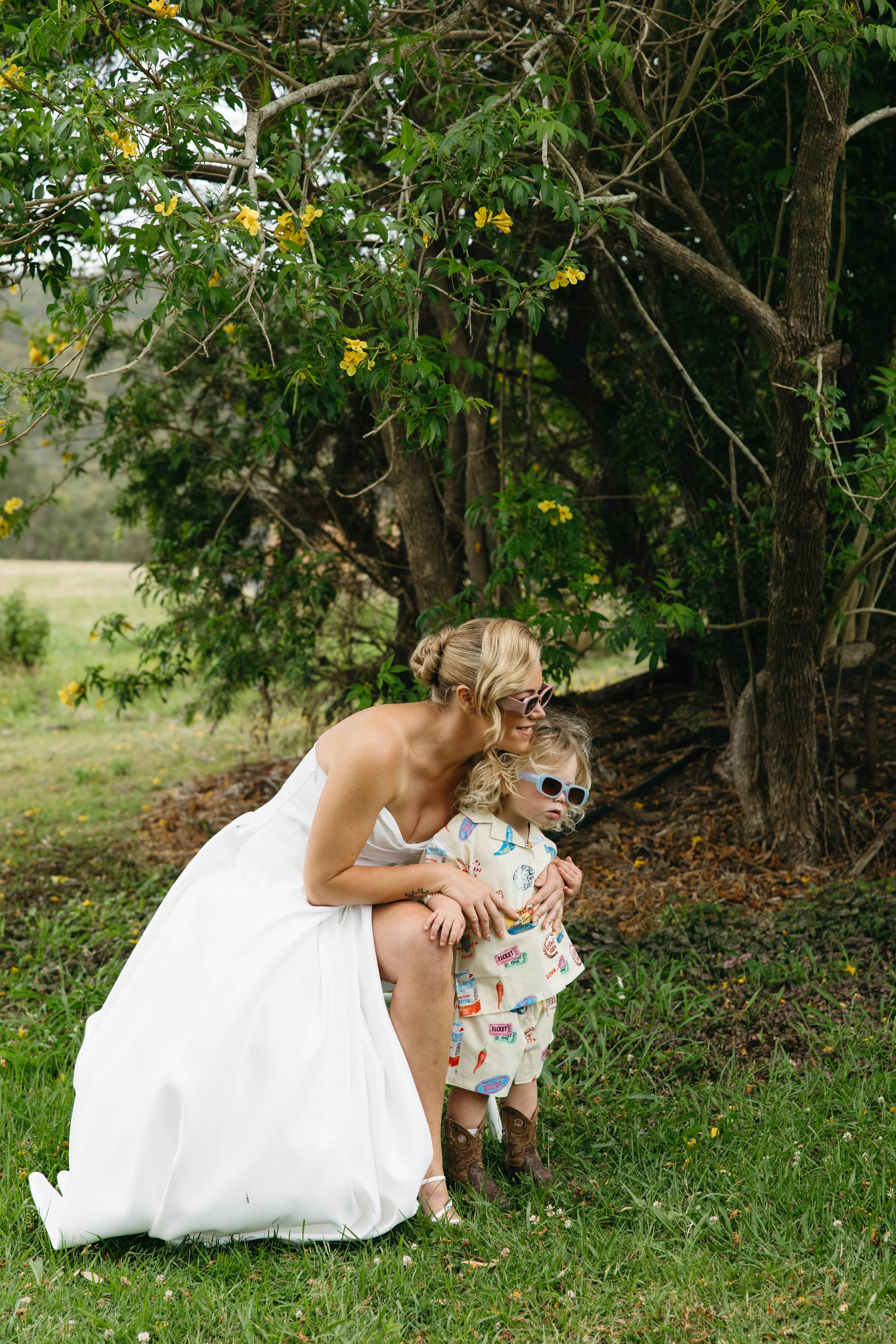 Bride sharing a moment with her son in cowboy boots