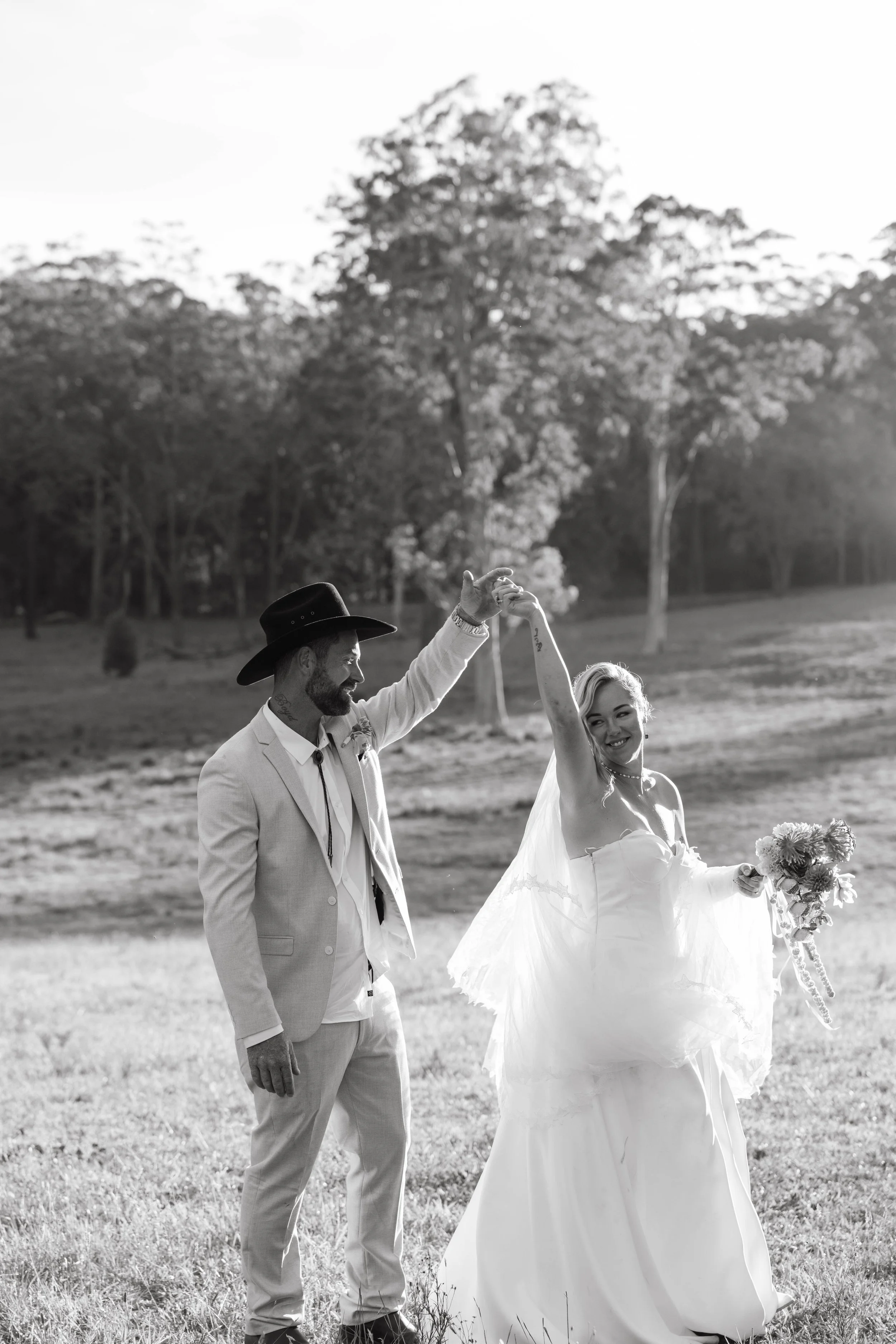 Black and white photo of bride and groom dancing at a Pacific Palms wedding, Mid North Coast