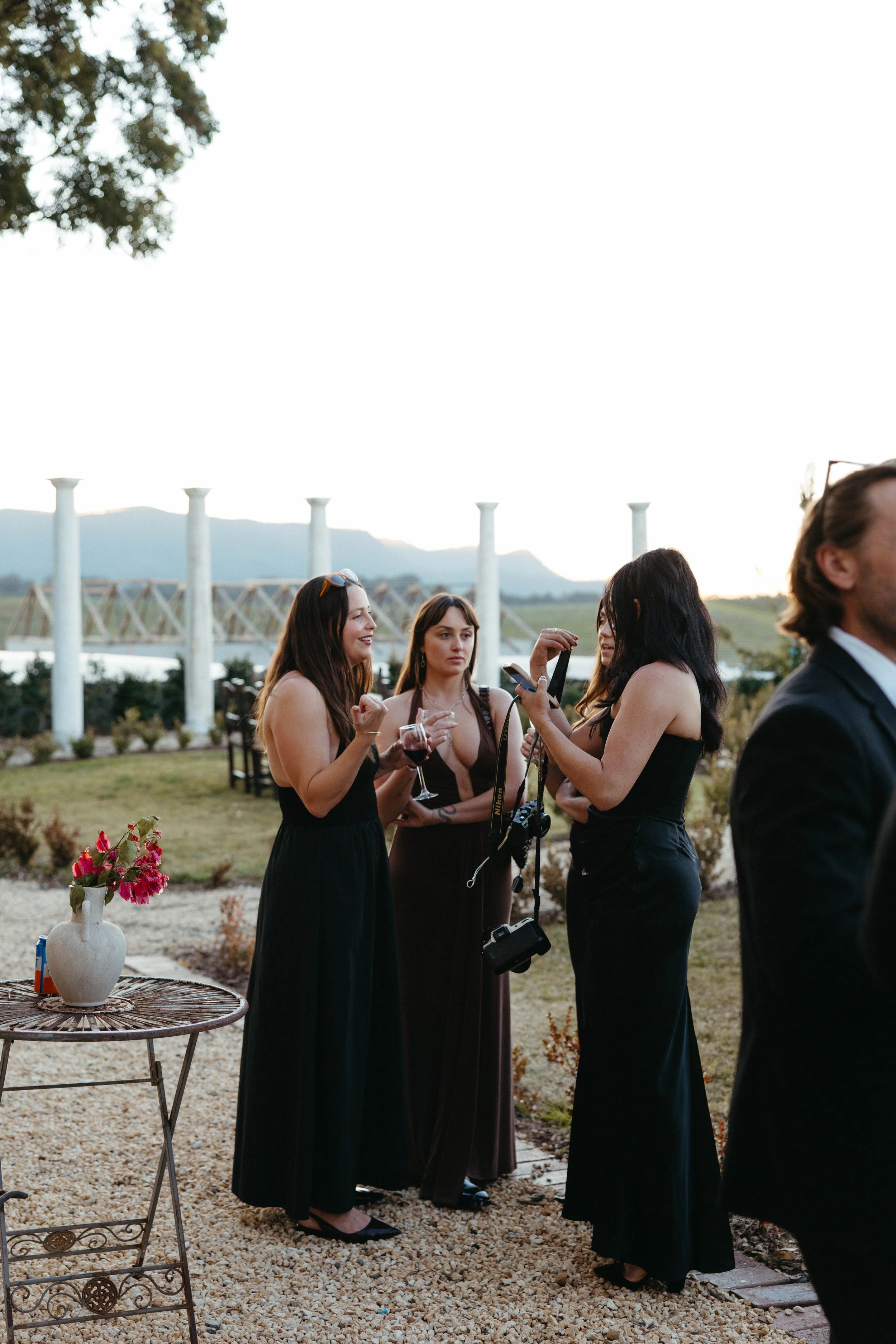 Bridesmaids enjoying a glass of wine at sunset at Villa Toscana, Hunter Valley