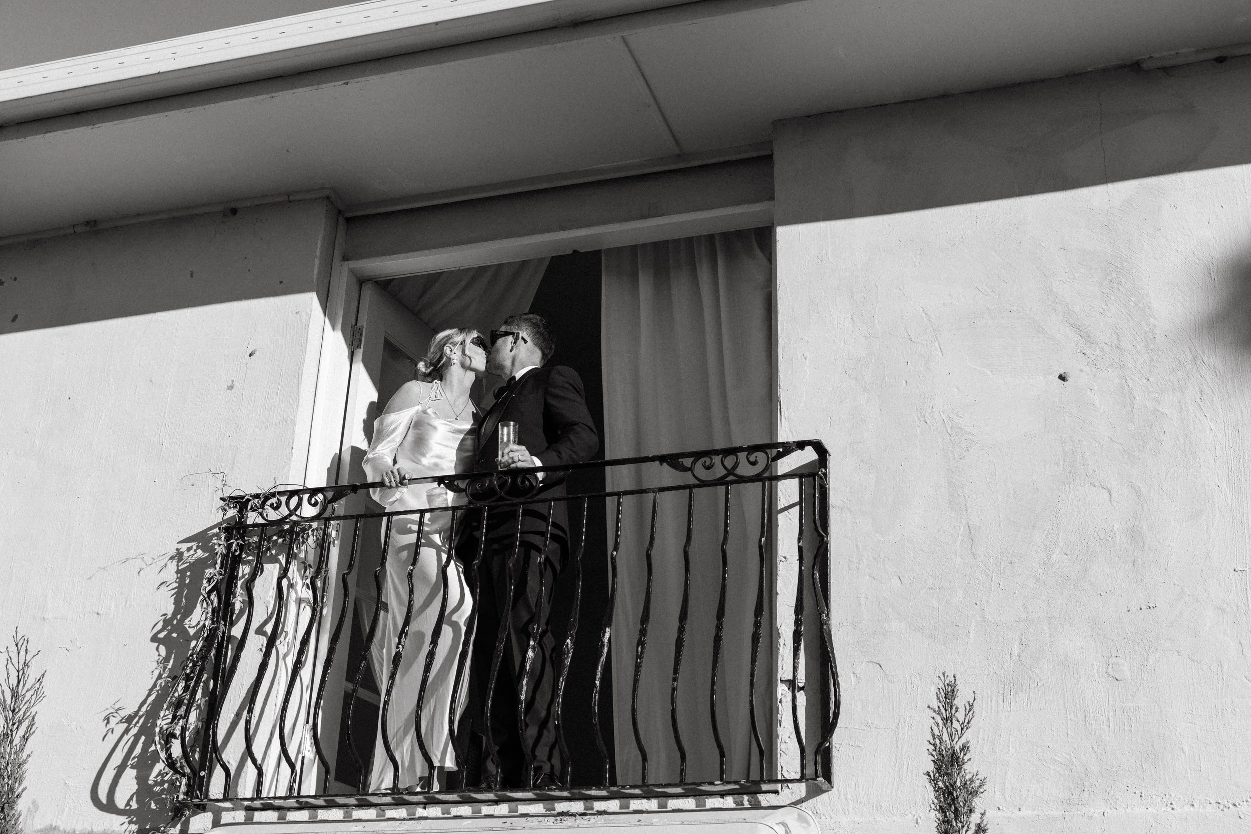 Bride and groom sharing a kiss on the balcony at Villa Toscana, Hunter Valley