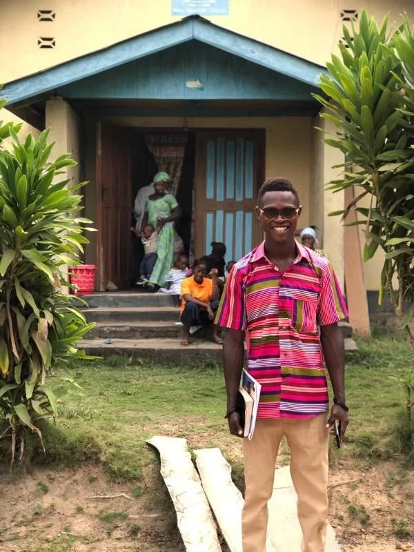 Growing the Grassroots staff standing outside of the New Apostolic Church in Tikonko, Sierra Leone