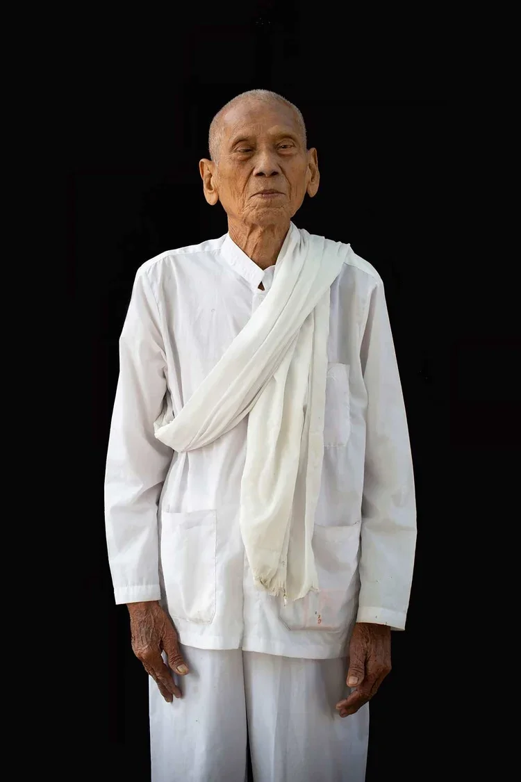 Ol Phang age 89: "I have lived at the Wat for 19 years. I do similar work as the nuns do, accepting prayers of patrons and some jobs for the monks. I went to school in the temple through grade 6. [There was no formal schooling in Cambodia until the 1