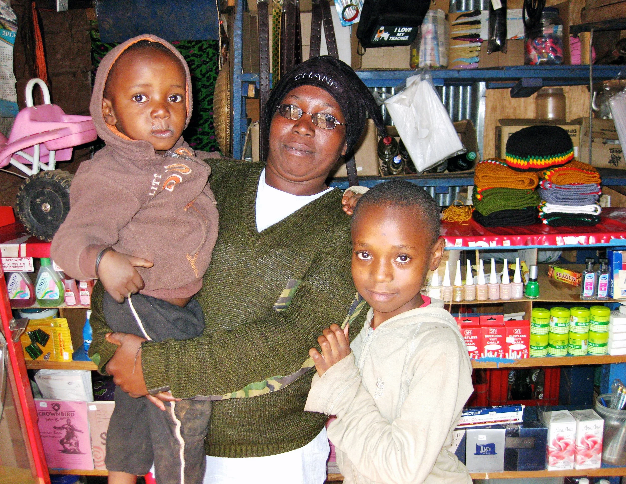 Everlyn, with children Trezlin and Barack, in her tuck shop