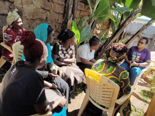 Community women in a discussion with Kijiji Cha Upendo staff