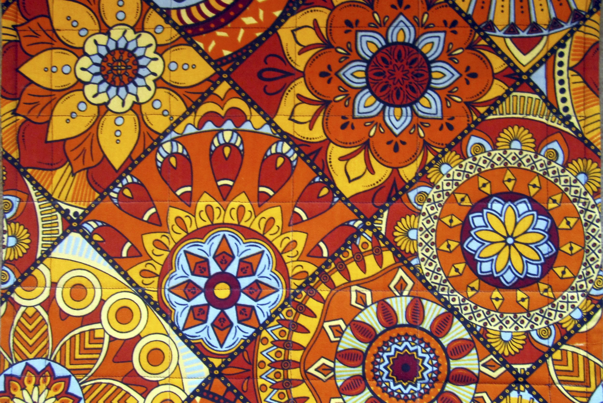 Orange placemat. 17.5” x 
13.25”, $45 a pair 
Made with authentic African wax-printed fabric, 100% cotton.  
WASHING INSTRUCTIONS:  Cool water, air dry, can be ironed. 