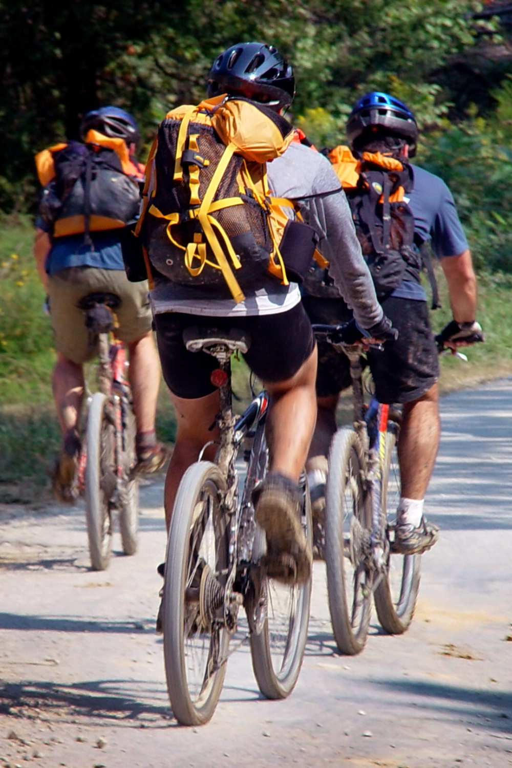 group of bikers riding together on a country path