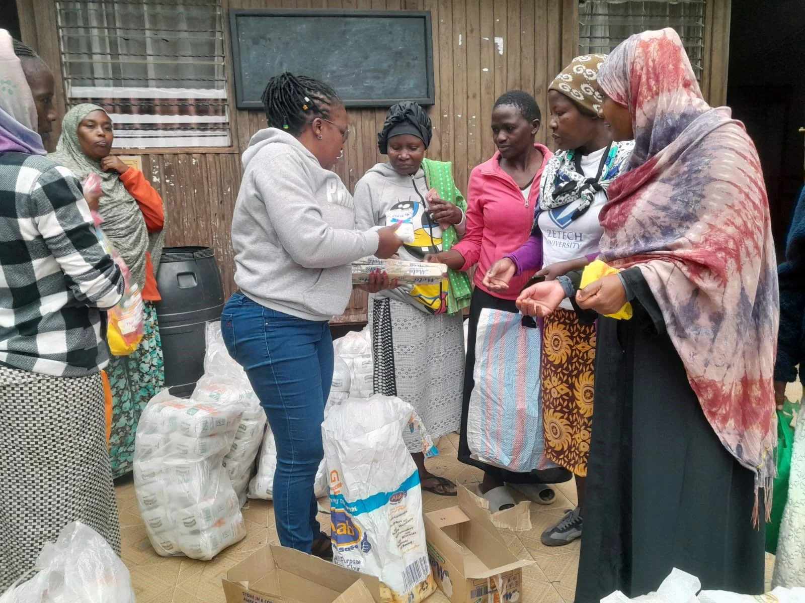 Distributing food rations to a group of women after the USAID cuts