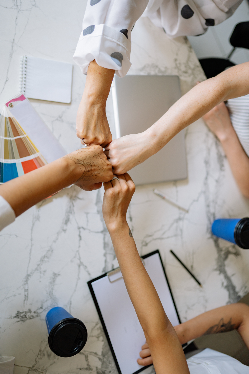 diverse group fist bumping