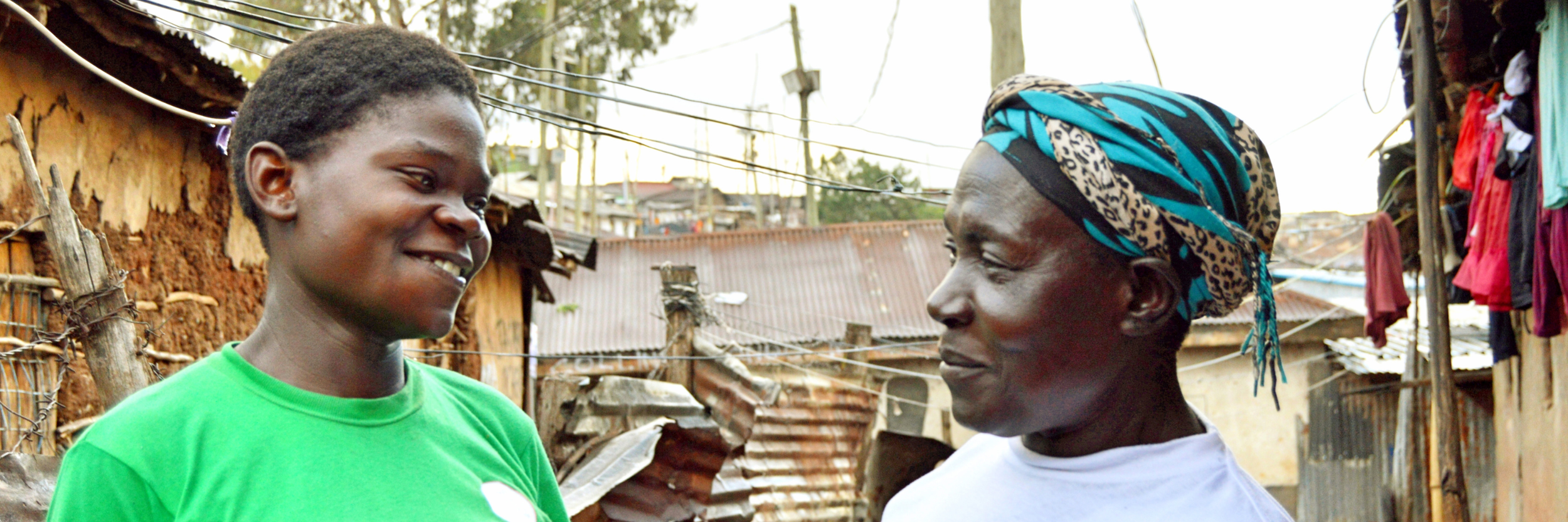 Caregiver and her teenage adopted daughter smiling