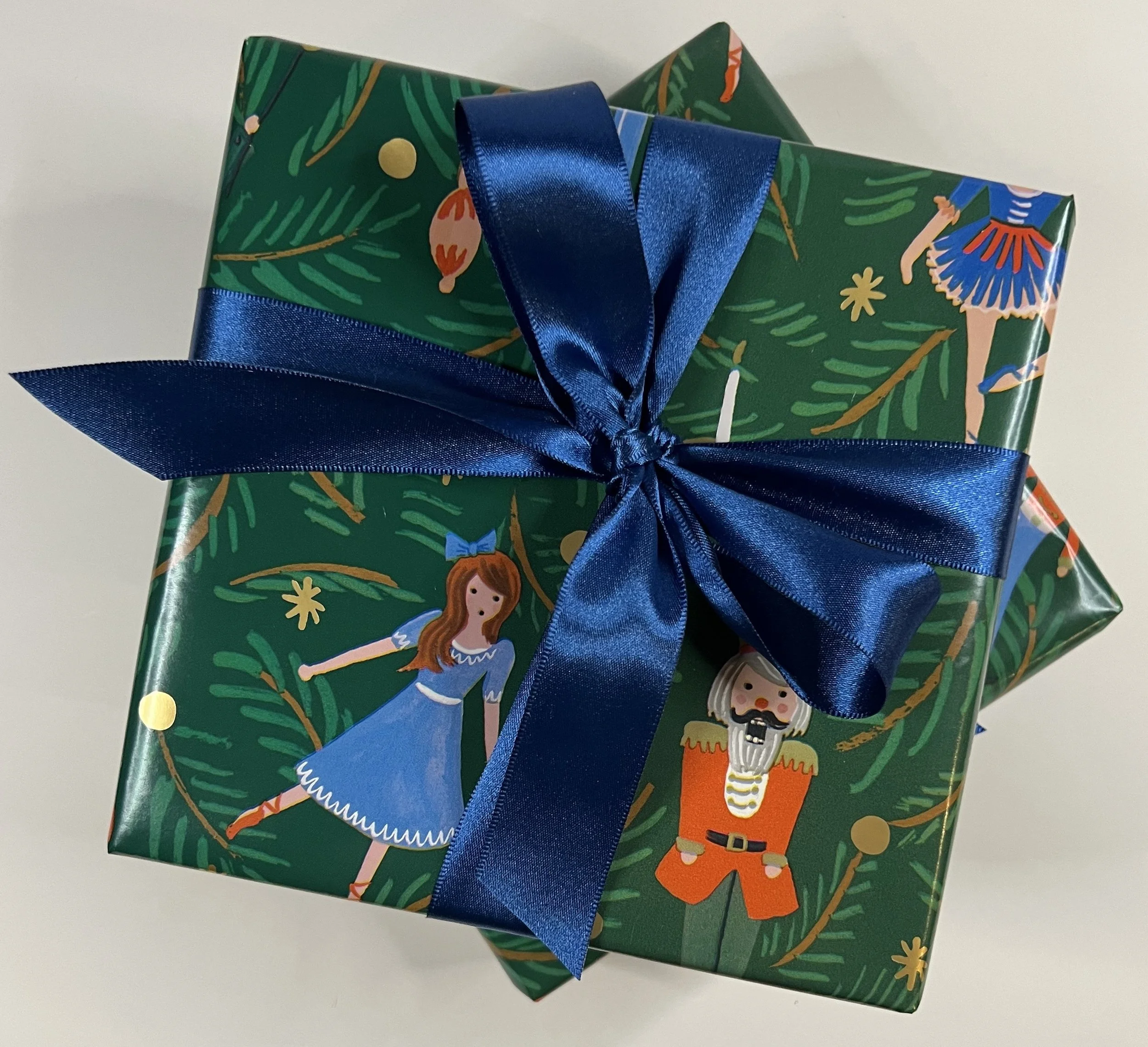 Wrapping nutcracker with blue bow.jpeg