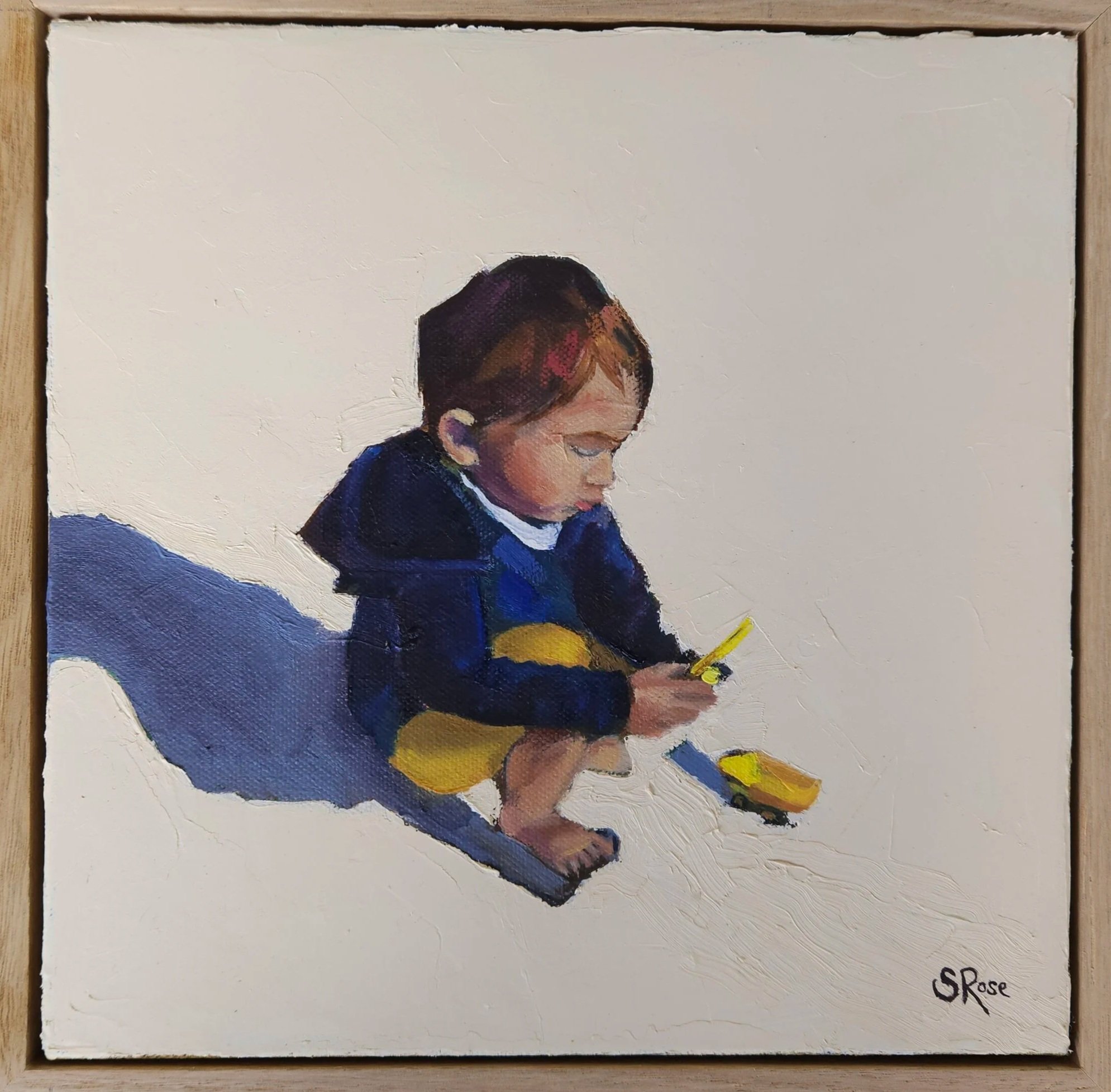 A painting of a young child sitting on the floor and playing with a yellow toy boat. The child is dressed in a dark jacket and yellow pants, with a white shirt underneath. The background is plain and light-colored, and the child's shadow is cast to t