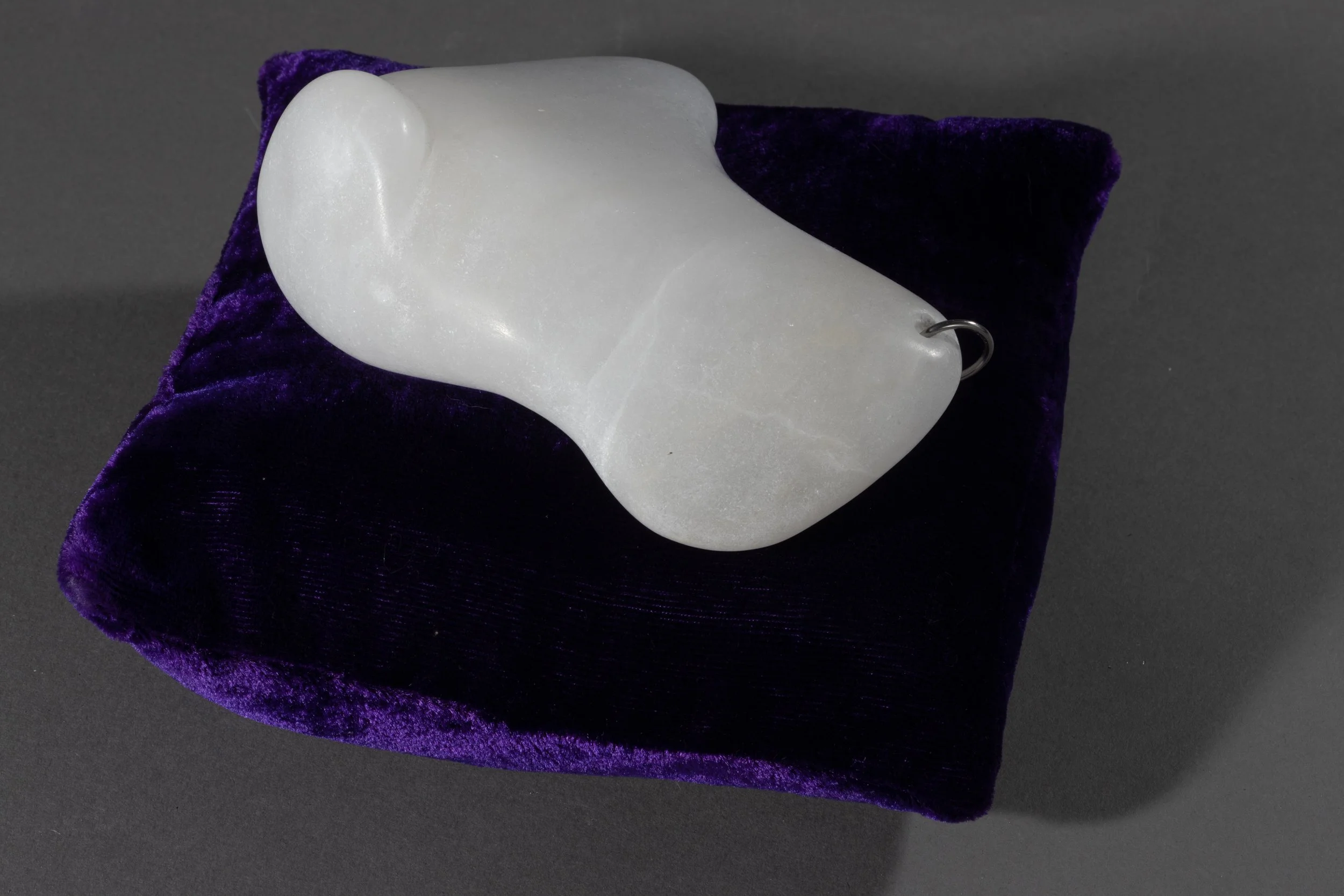 Tidbit No. 5, 2023, Alabaster, stainless steel ring, velvet pillow, 3 ¾ x 7 ½ x 7 ½ in (Photography: Richard R Vallon, Jr)