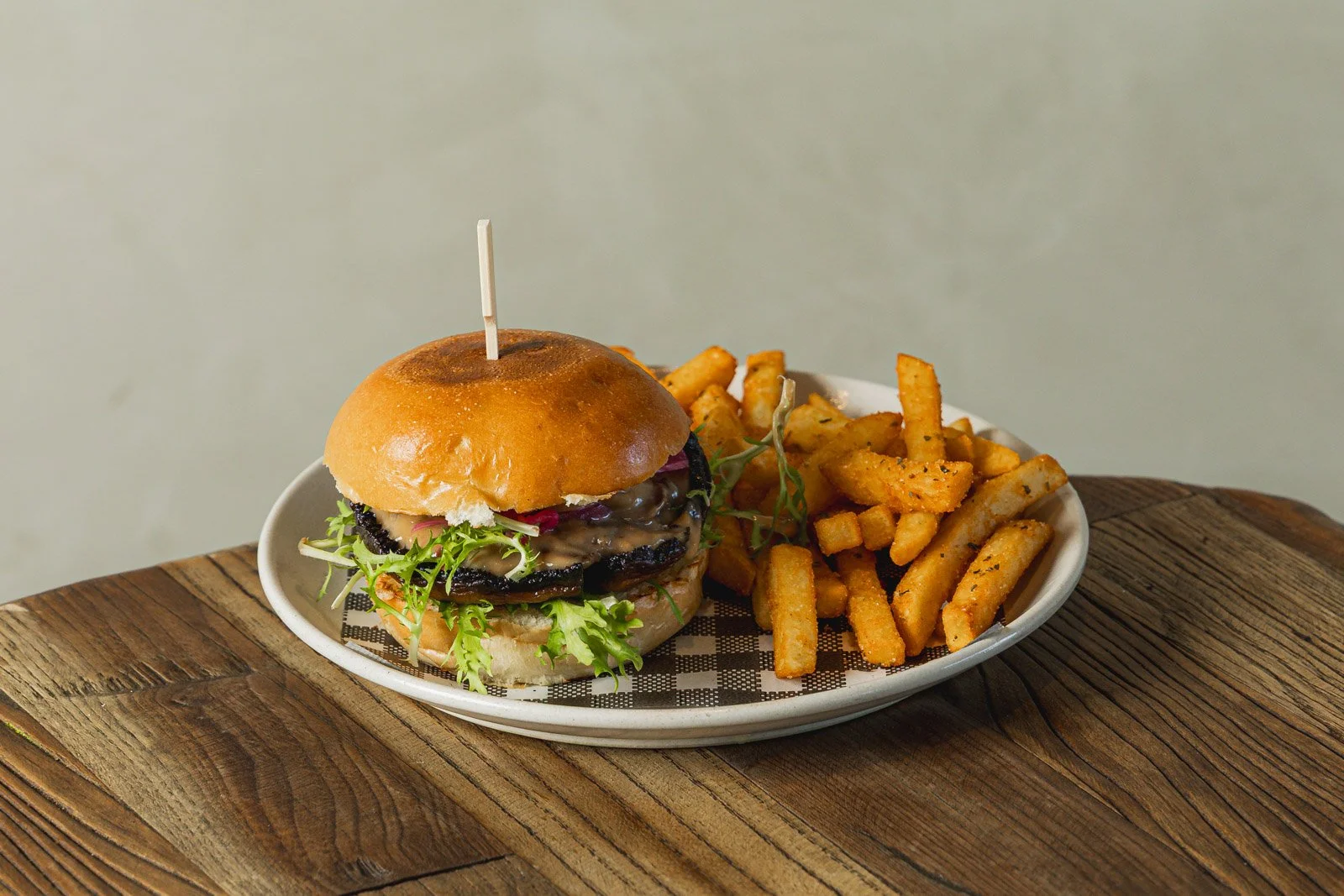 Burger with fried potatoes on a plate