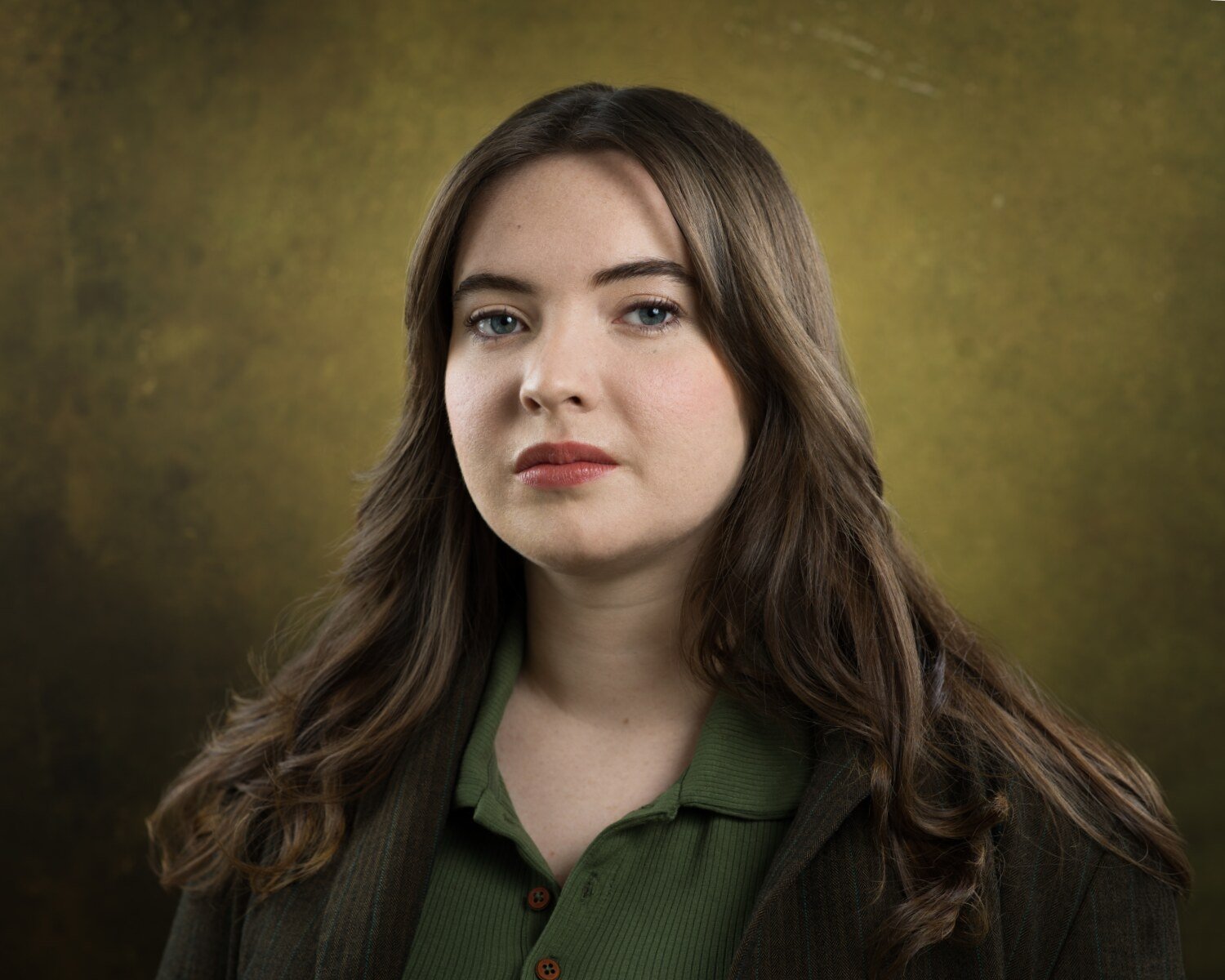 Headshot of Skyela Jones in a green polo and dark textured jacket, featuring a steady and resolute expression. Her direct, intelligent gaze suggests a grounded, capable character, ideal for procedural forensic roles and gritty contemporary dramas.
