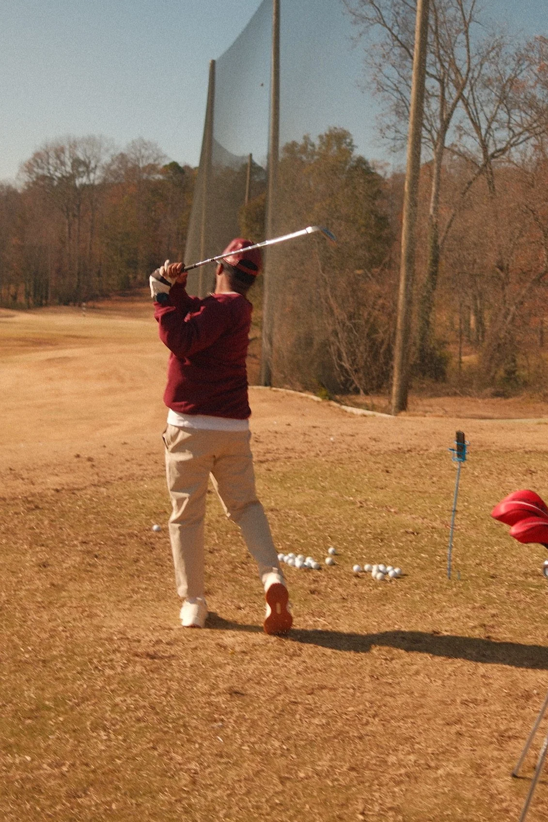 a person participating in a swing easy. golf clinic for beginners and high-handicap golfers.