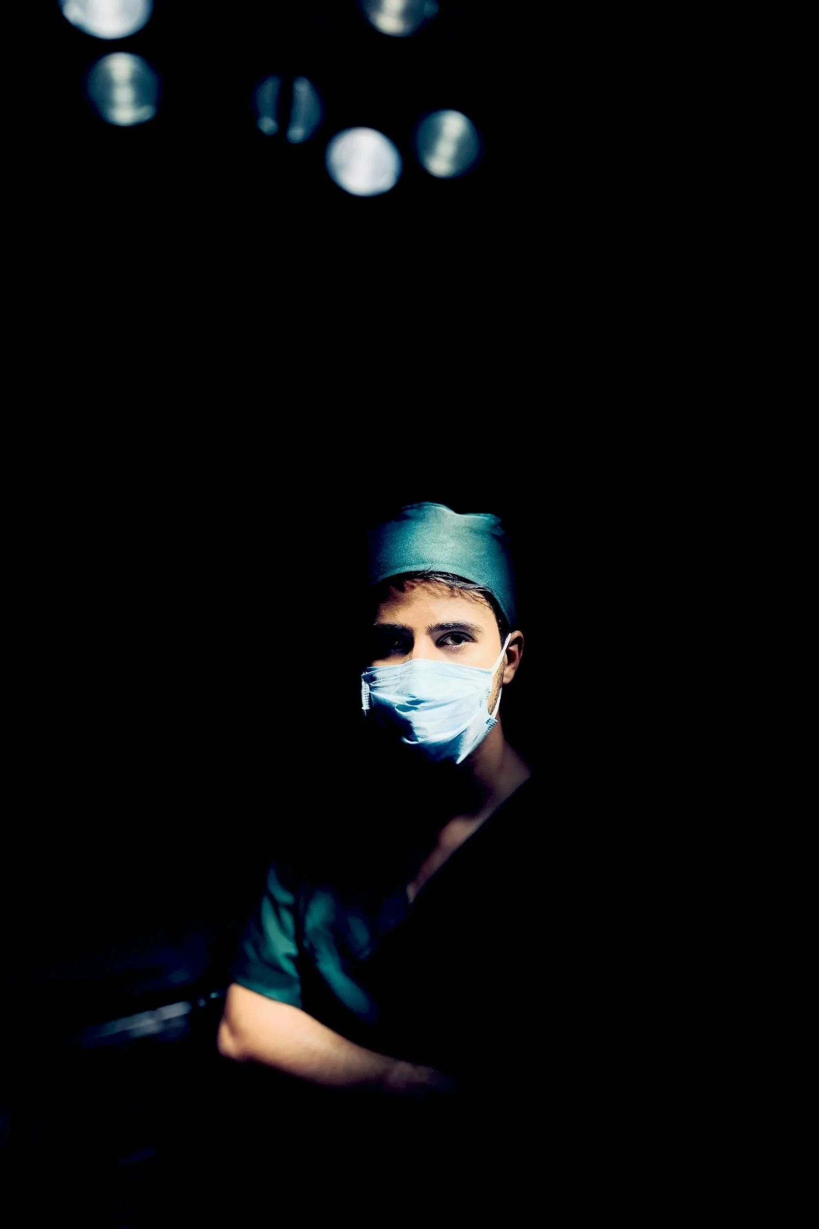 doctor in dark lighting with mask on