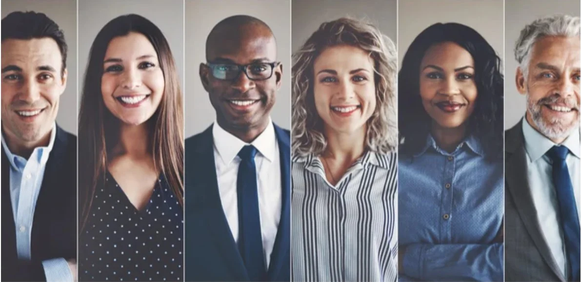 Group of diverse professionals smiling in a business setting