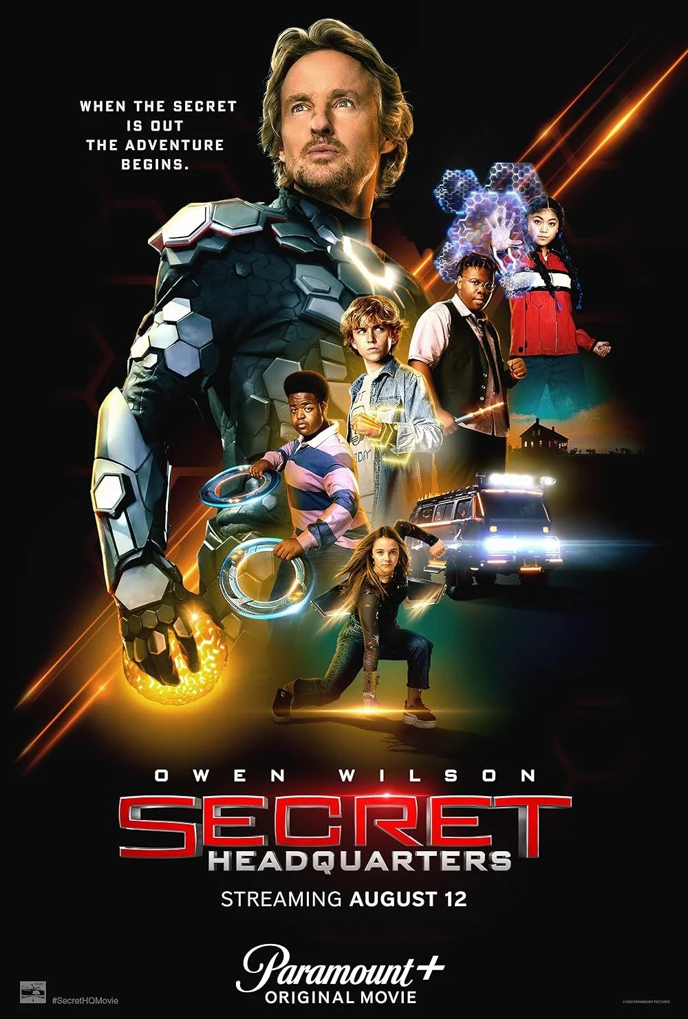 Promotional poster for the movie 'Secret Headquarters' showing a man in a high-tech suit with five kids, some with powers or gadgets, and a police vehicle in the background with the release date August 12 and streaming on Paramount+.