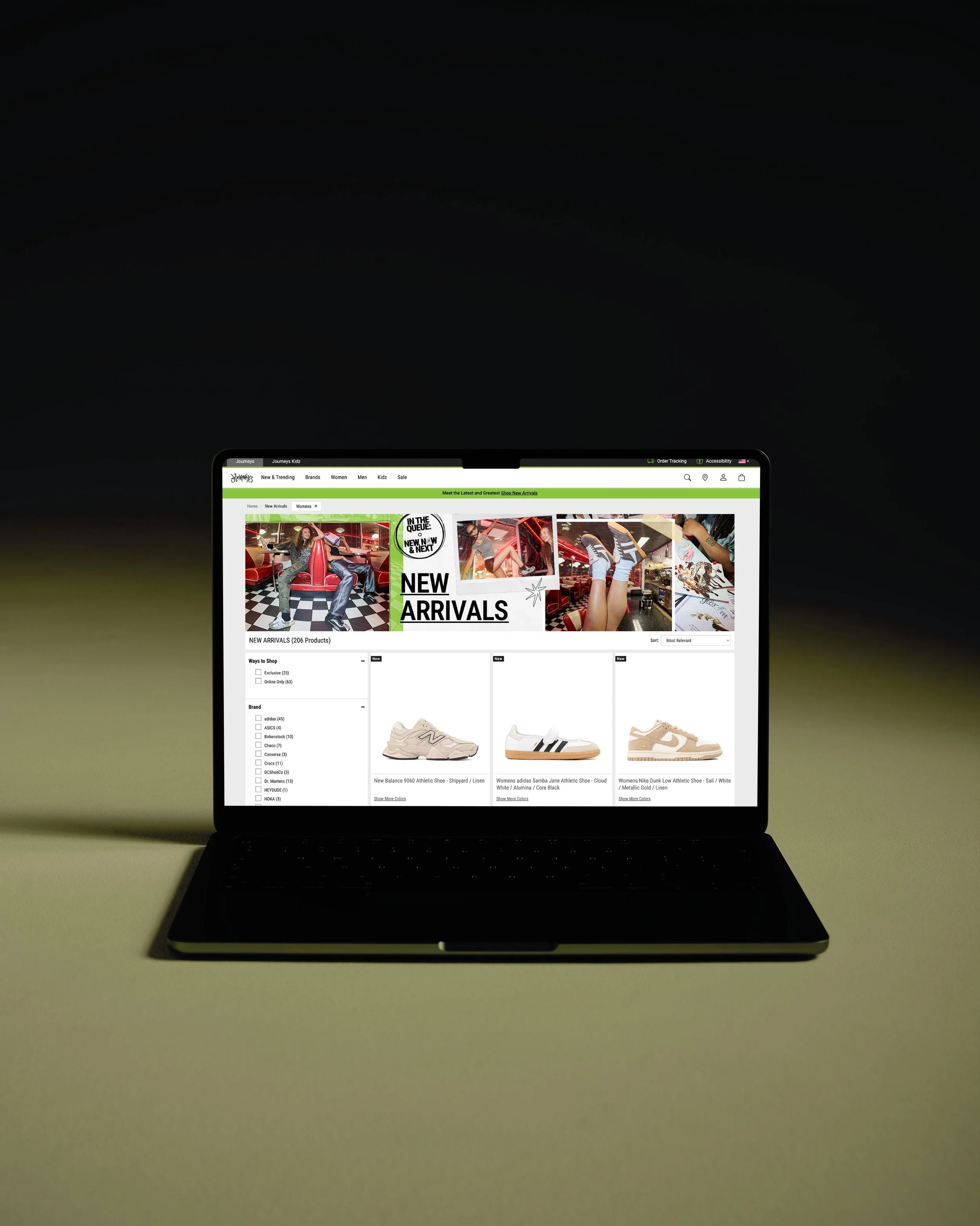 Laptop displaying an online shoe store with various sneakers and athletic shoes on the screen.
