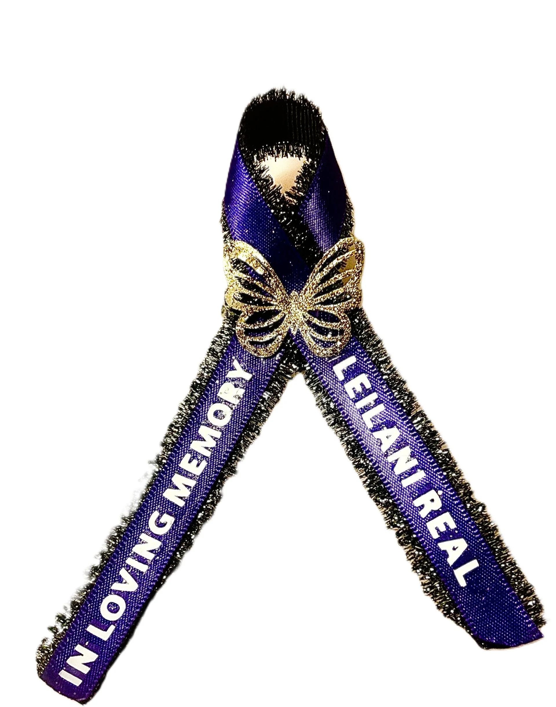 Purple ribbon with black and gold edges, featuring a gold butterfly, with white text reading 'LEILANI REA' and 'LOVINGMEMORY'.