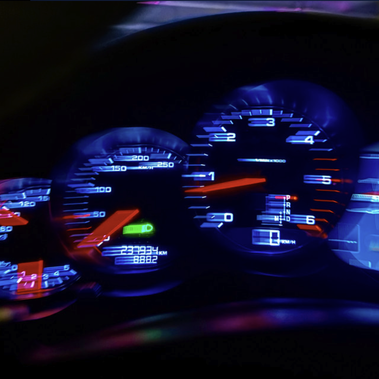 Illuminated car dashboard at night showing speedometer, tachometer, fuel gauge, odometer reading 23,9934 km, and gear indicator in drive. George Myer, VV Ace, 23
