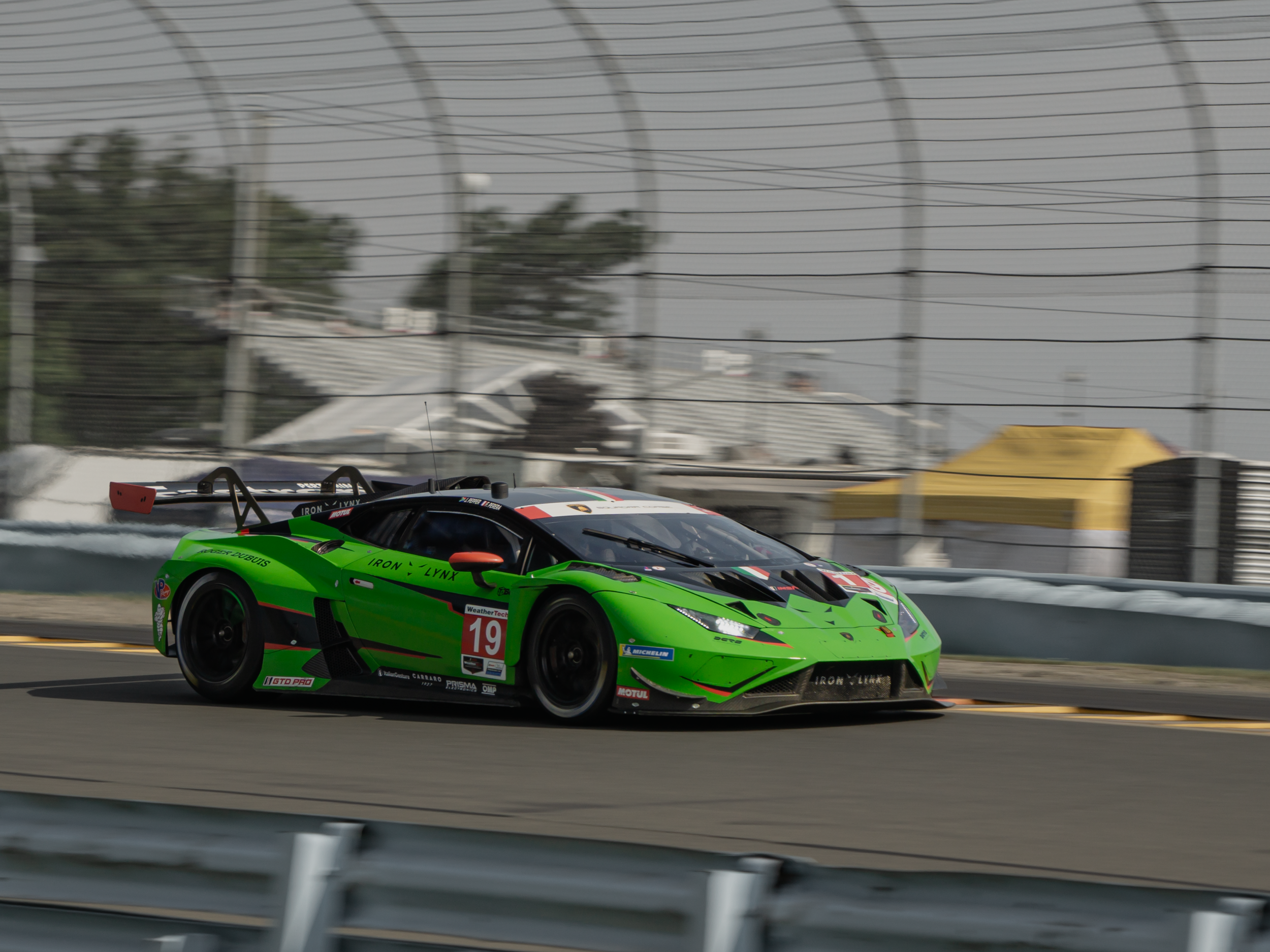 The #19 Iron Lynx lamborghini huracan gt3 evo II exiting turn 8 at Watkins Glen during the 2024 IMSA Sahlen's Six Hours of the Glen
