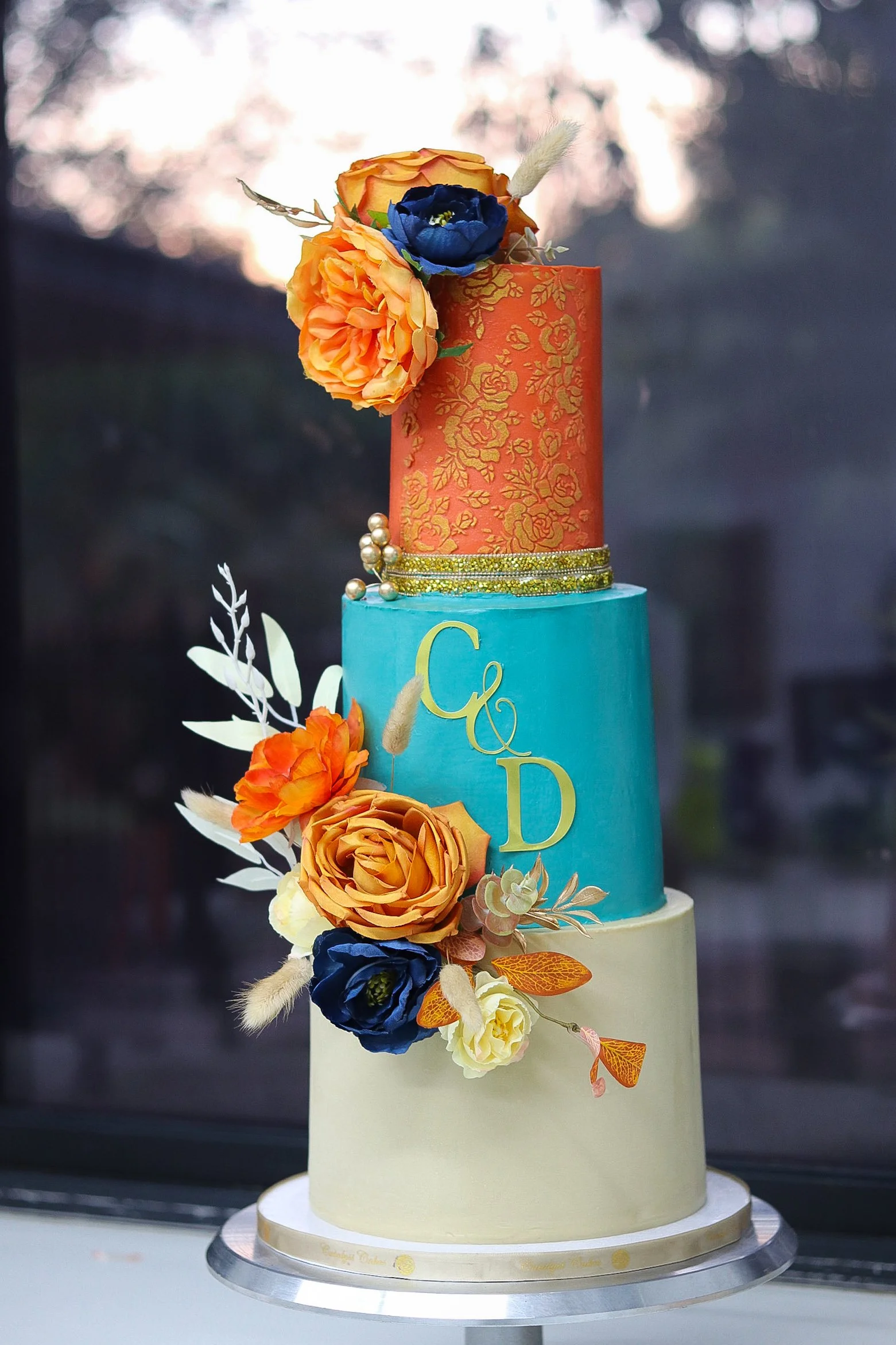 Three-tier wedding cake with floral decorations  perfect for weddings and milestone birthdays.