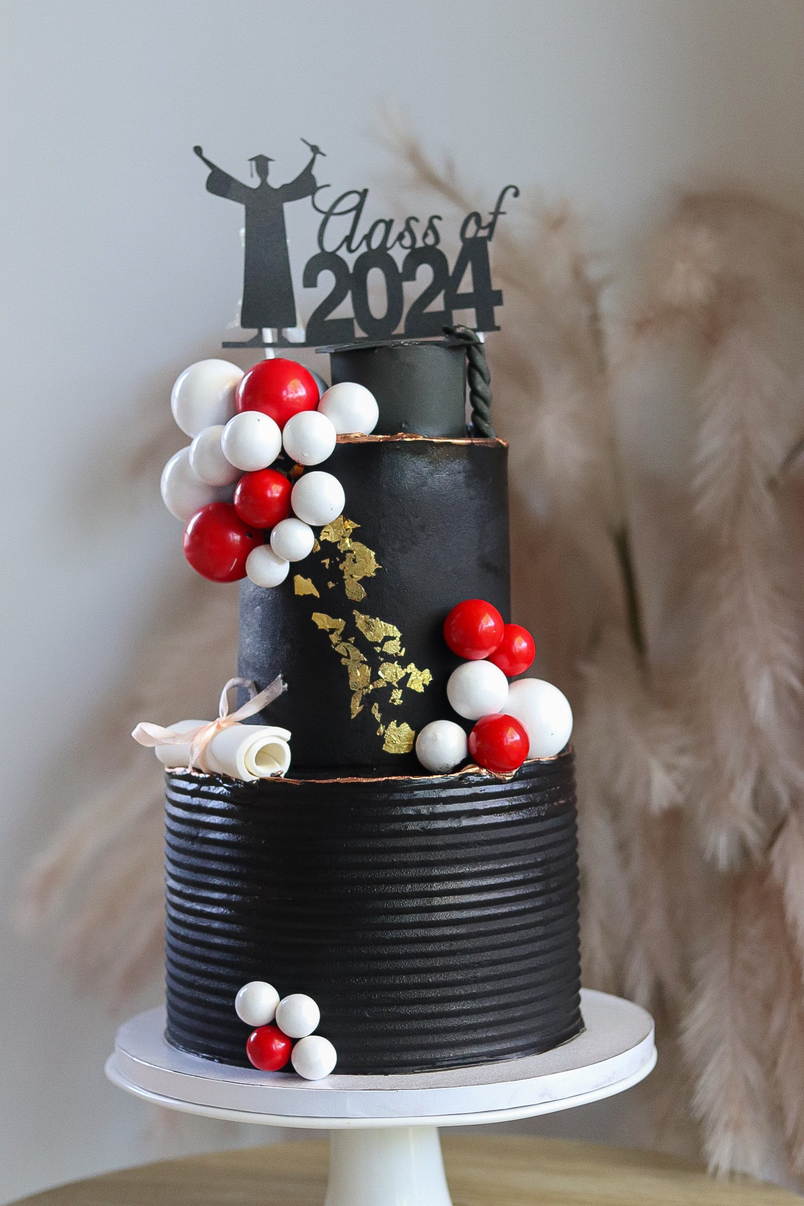 Black graduation cake with gold leaf accents. This is ideal for graduation celebration cakes and the celebration cakes. Made to order in Darwin, NT.