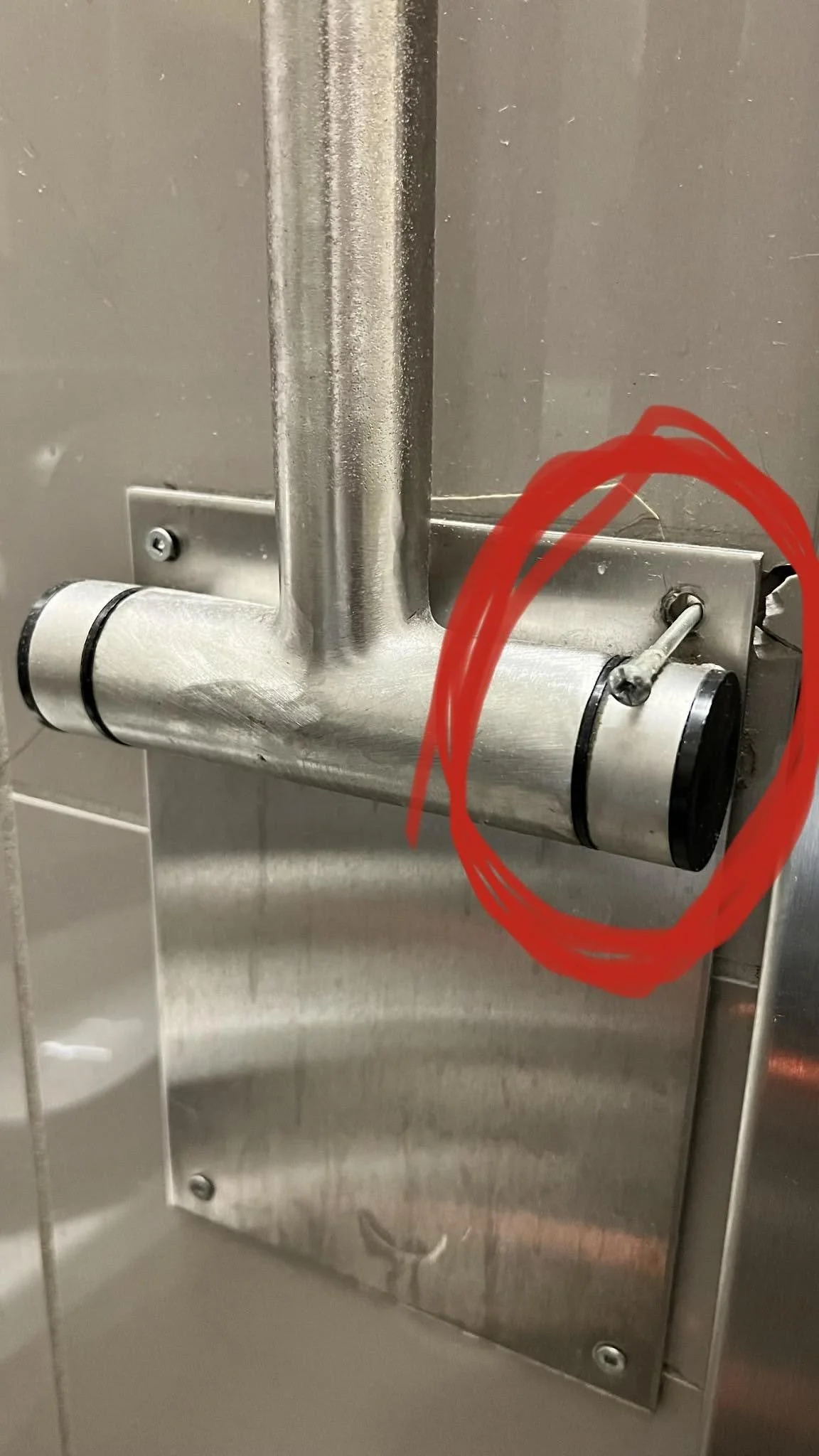 Broken door handle with metal piece hanging out