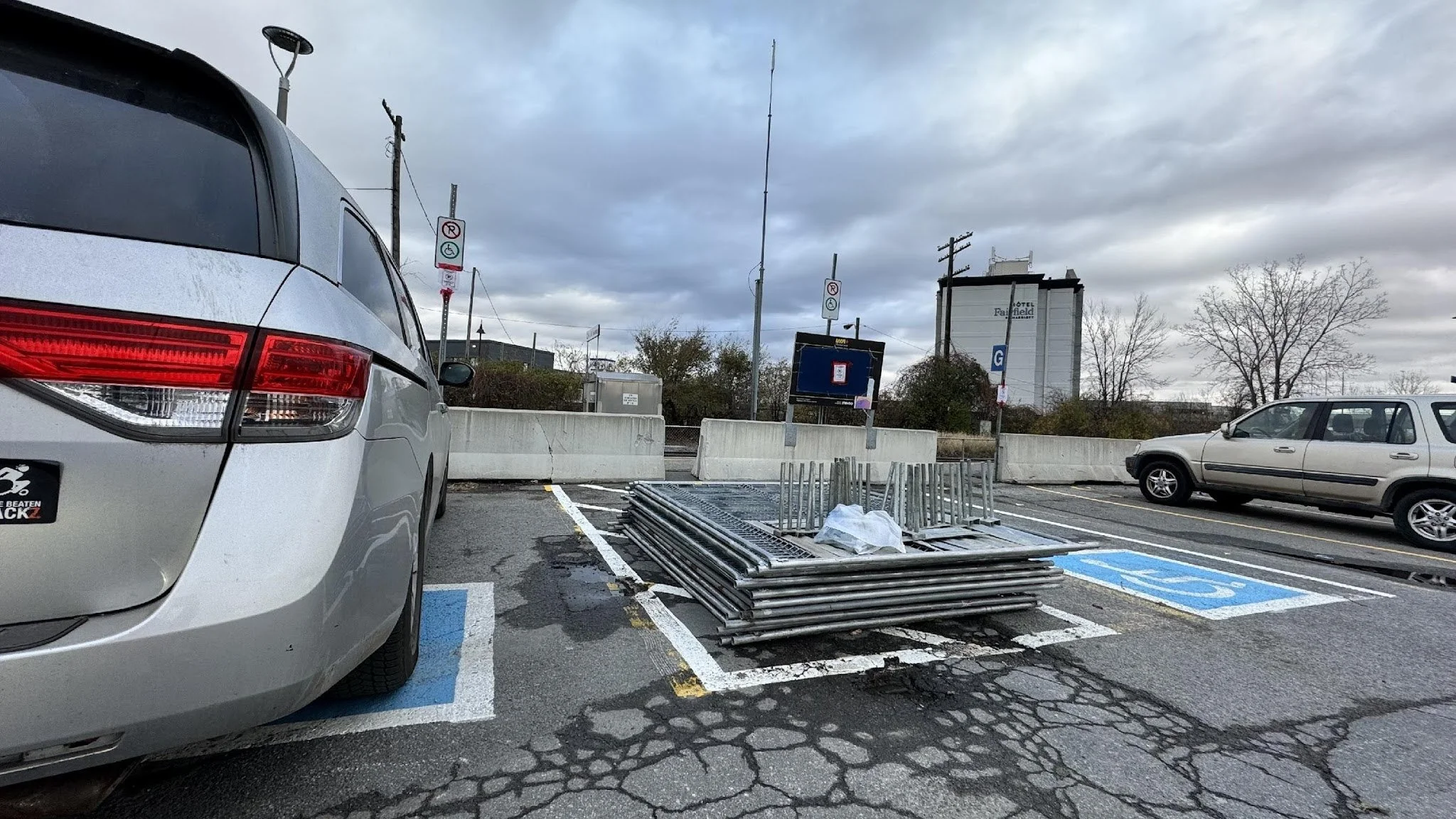 Construction zone with metal fencing placed directly on accessible parking spot