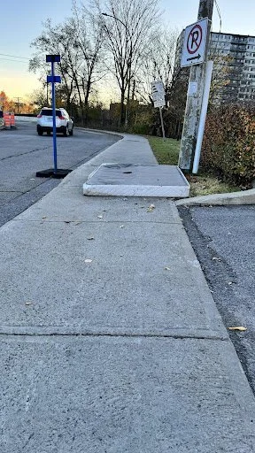 Sidewalk with raised curb making rolling access impossible