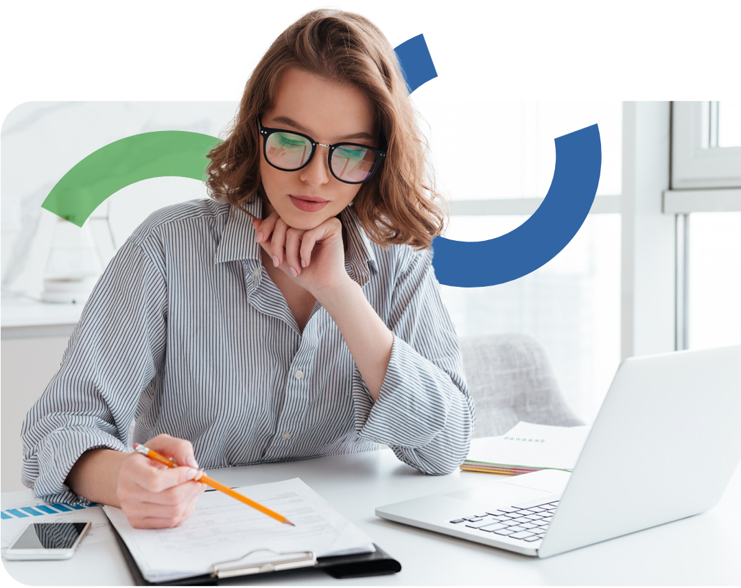 Woman with glasses working at a desk with a laptop, notebook, and smartphone, with colorful graphic elements in the background.