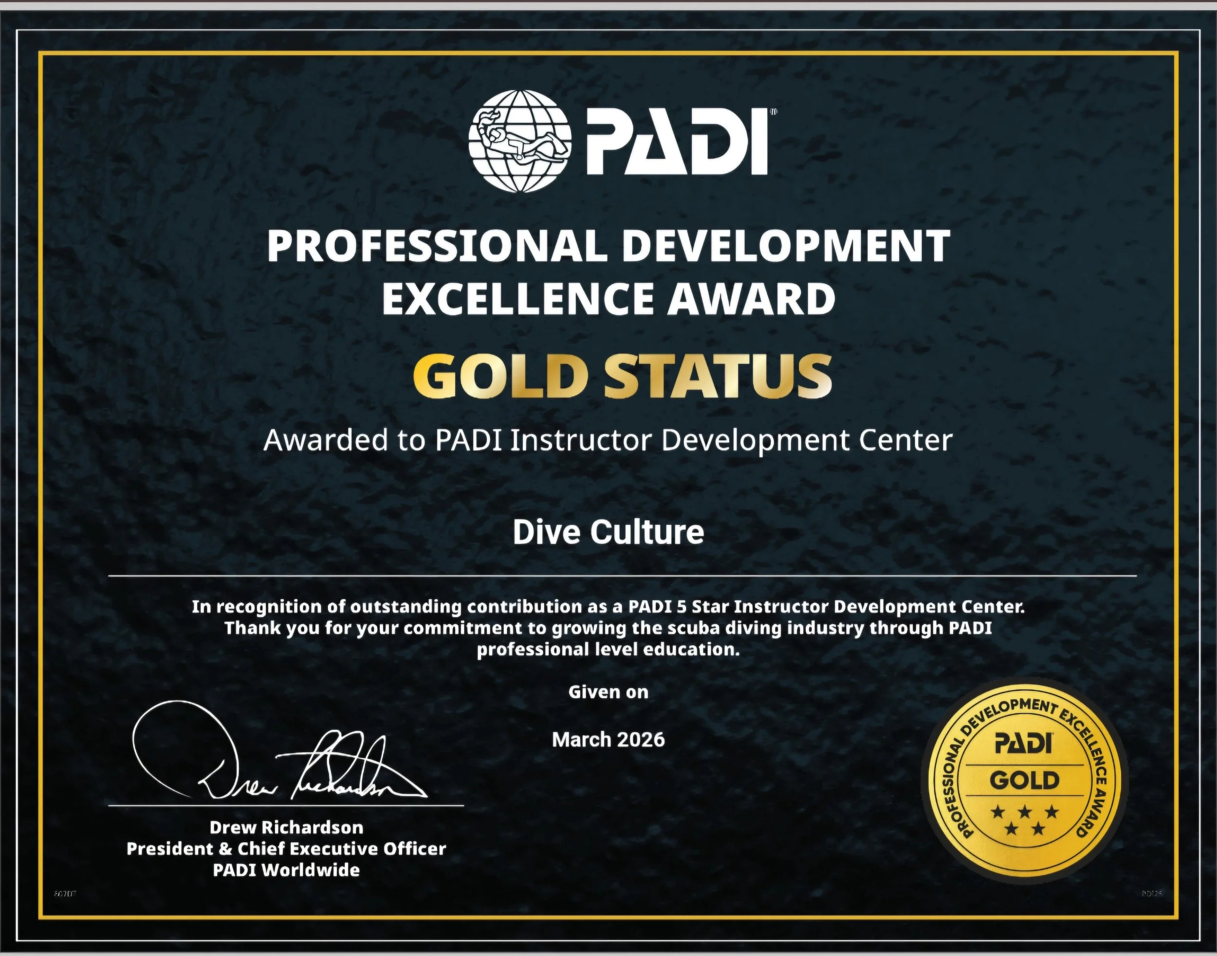 PADI Professional Development Excellence Award certificate with a gold seal, awarded to PADI Instructor Development Center Dive Culture in March 2026, signed by Drew Richardson.