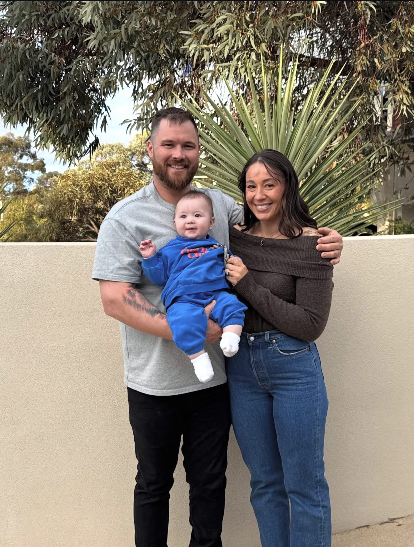 This is a picture of the family who own the business, a married man and woman with a young baby.