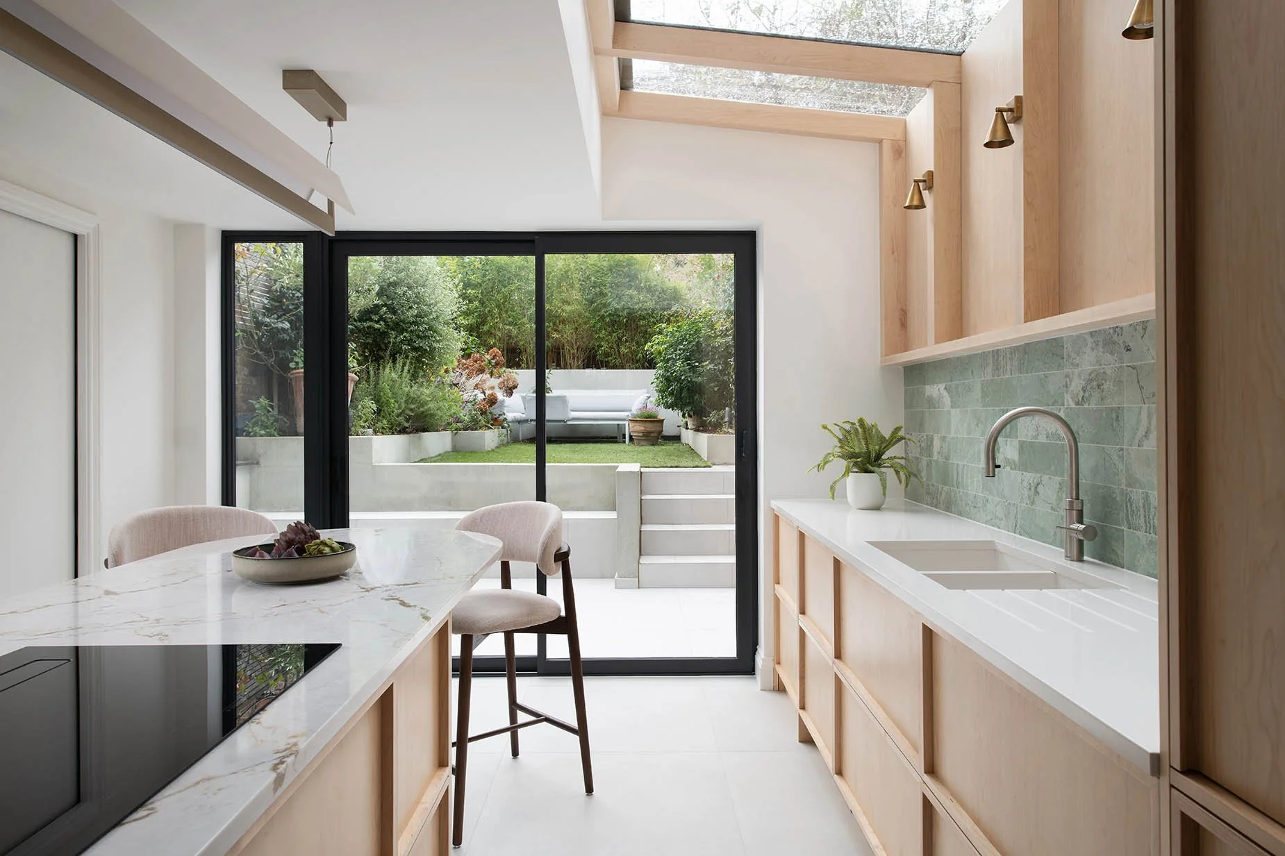Calm Curation. Designed as a calming haven for both everyday life and entertaining, this project focused
on flow, storage, and a strong connection to nature. A custom maple kitchen was designed
to keep surfaces clear and the space feeling light, airy