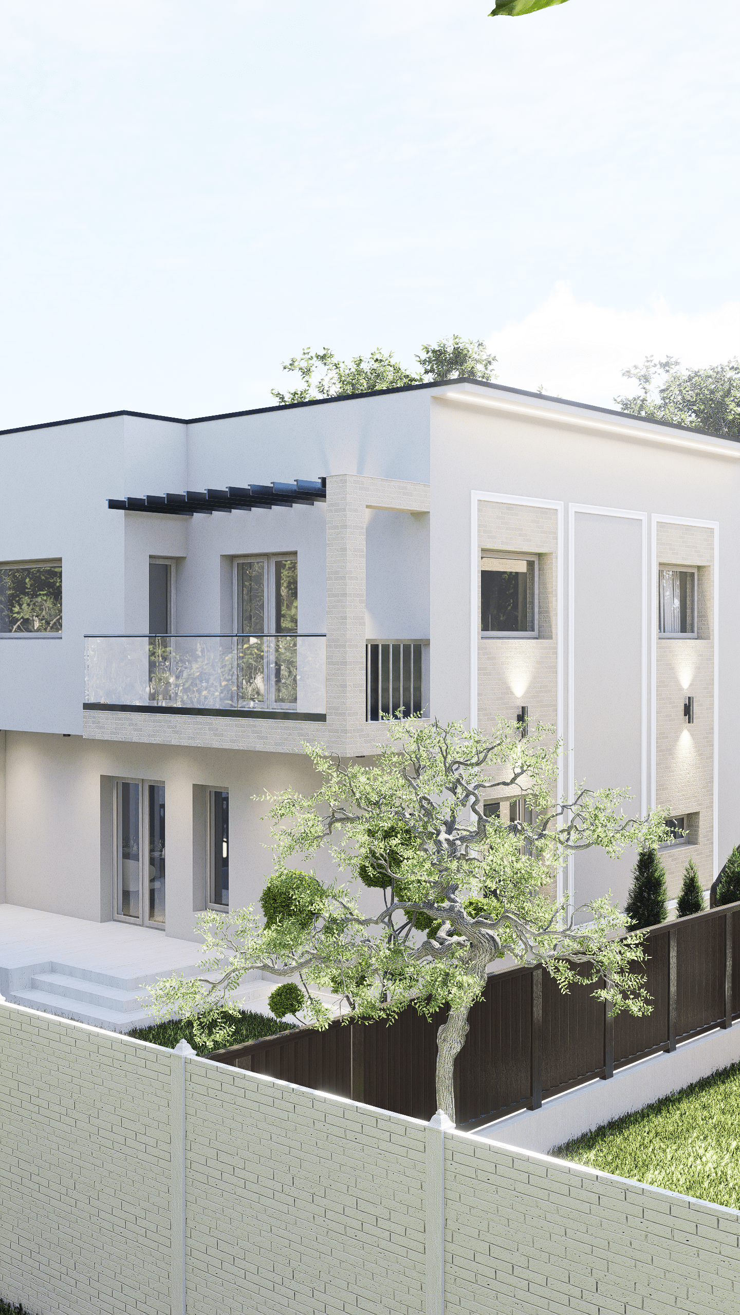 Modern white residential building with large windows, a balcony with glass railing, and a tree in the backyard enclosed by a beige brick and a dark wooden fence.