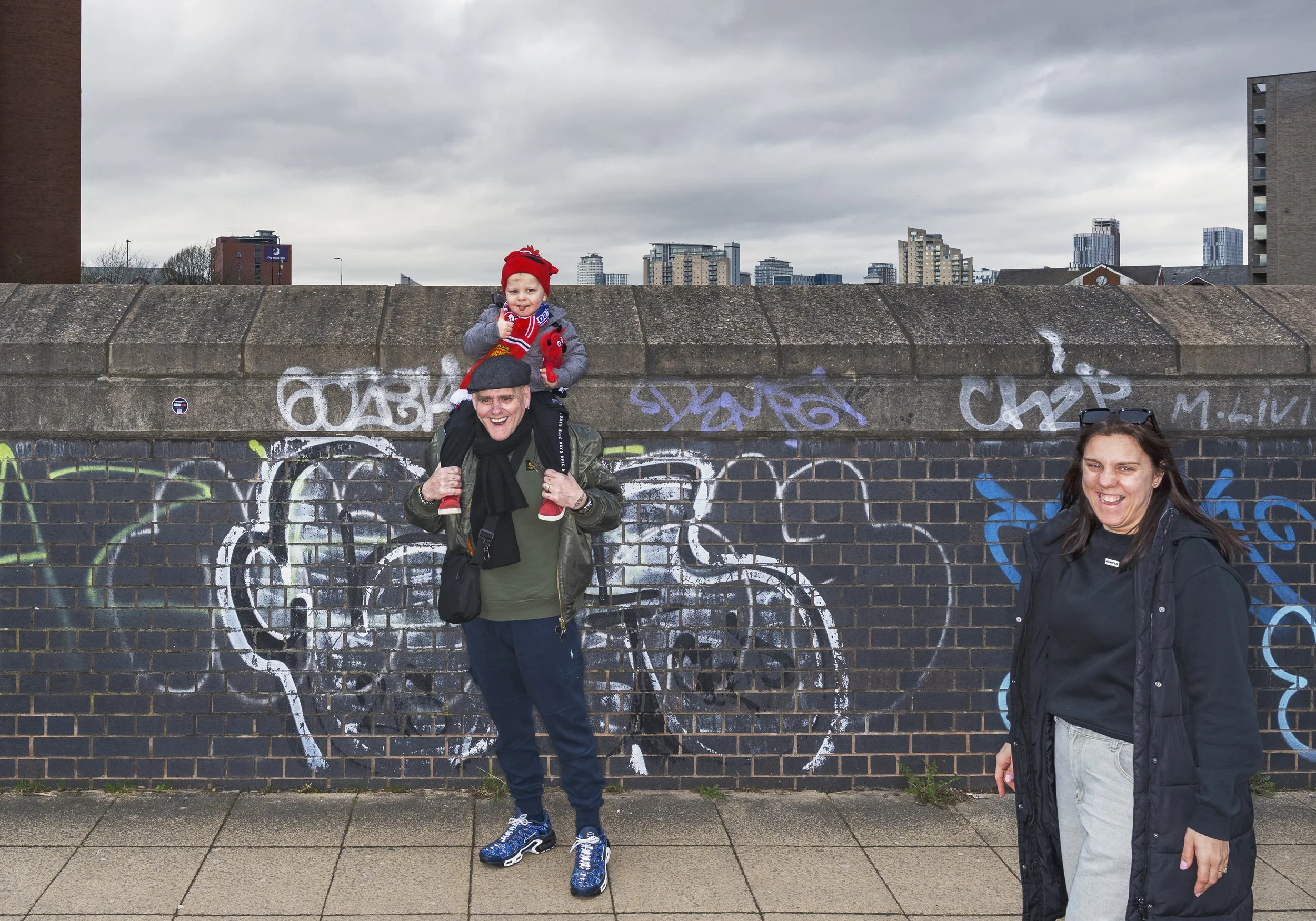 Three generations of Red Devil fans on their way to see a match against Crystal Palace.