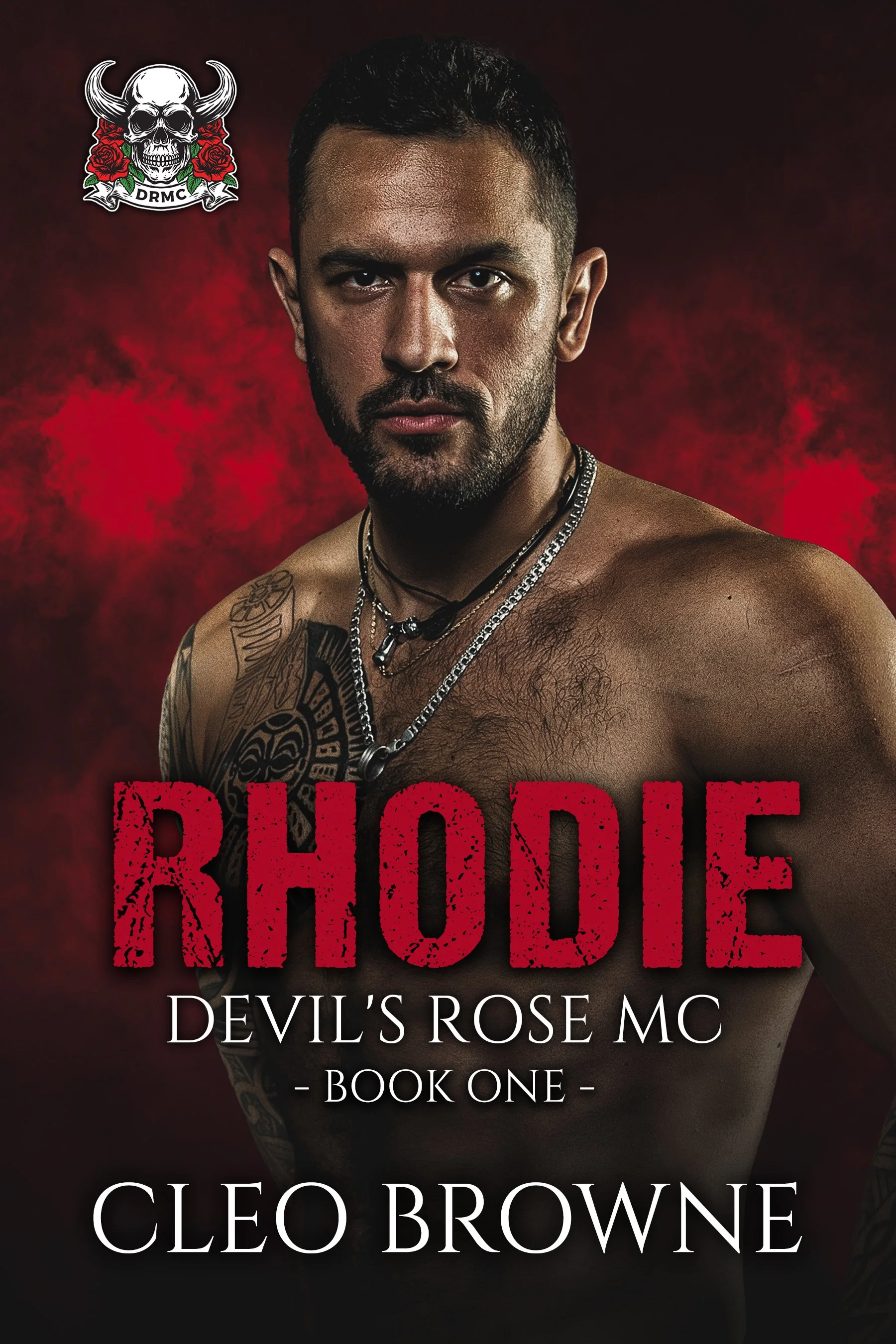 Book cover for 'Rhodie: Devil's Rose MC' by Cleo Browne featuring a shirtless man with tattoos and multiple necklaces, set against a dark red smoky background with a skull logo in the upper left corner.