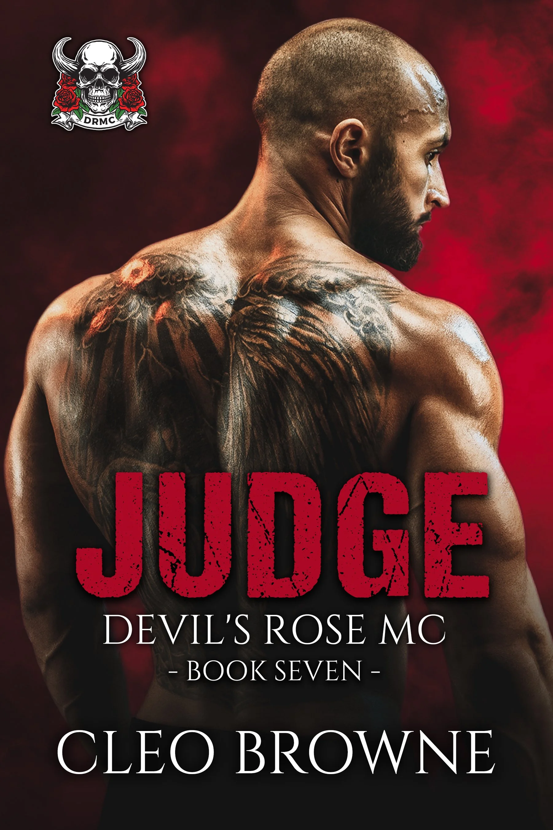 A muscular man with a beard, looking to his right, with tattoos on his left shoulder and back, stands against a red and black background. The title 'JUDGE' in bold red letters, the subtitle 'Devil's Rose MC - Book Seven' in white, and the author's name 'Cleo Browne' are displayed. A logo featuring a skull with horns, roses, and the letters 'DRMC' is in the top left corner.