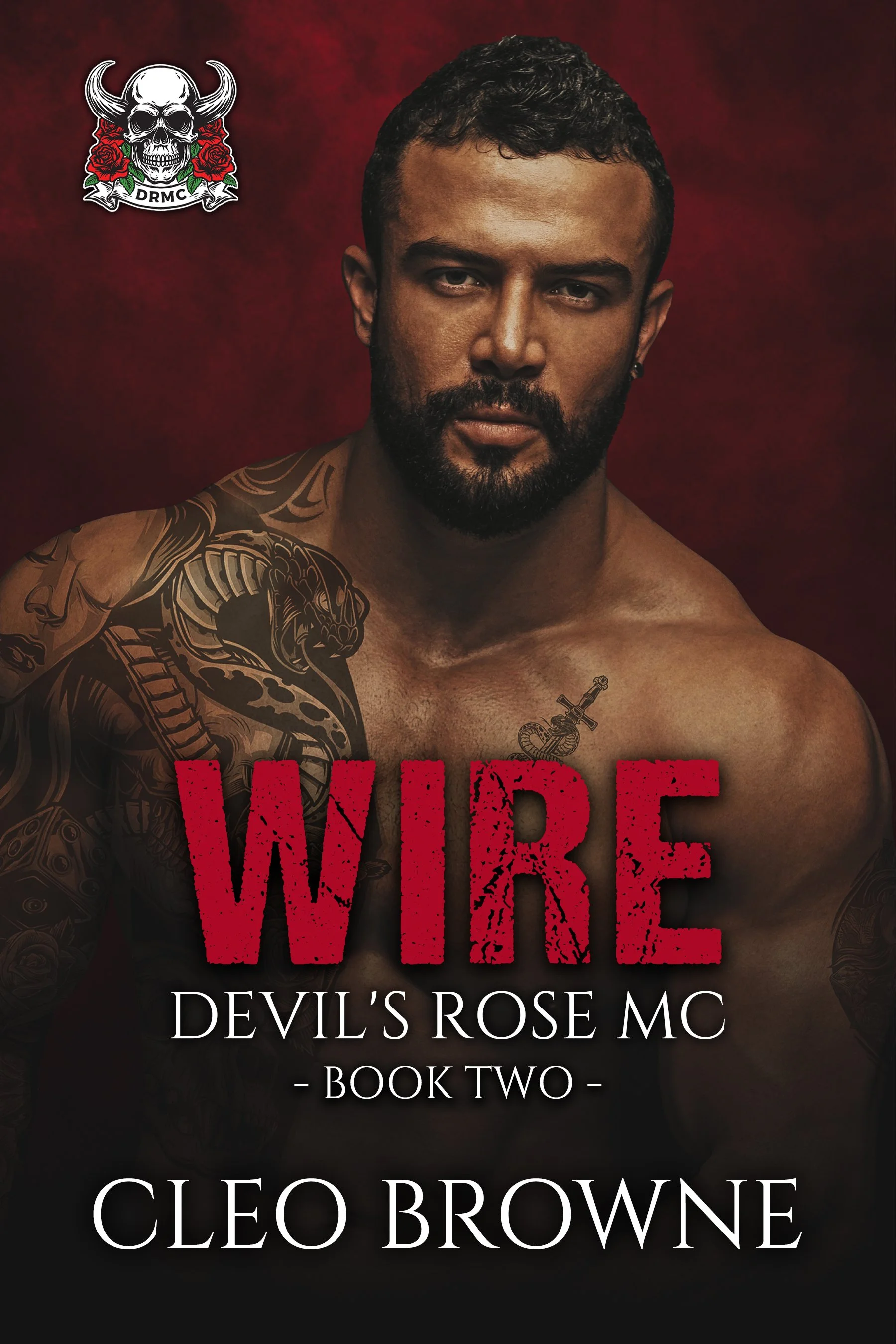 Book cover for 'Wire: Devil's Rose MC, Book Two' by Cleo Browne. Features a shirtless man with tattoos and a serious expression against a dark red background. Contains a skull logo with roses and the letter 'DRMC' in the top left corner.
