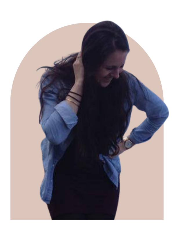 Young woman (Sarah Elizabeth Lahoud) with long dark hair laughing, wearing a denim shirt over a black top, standing against a blush pink background.