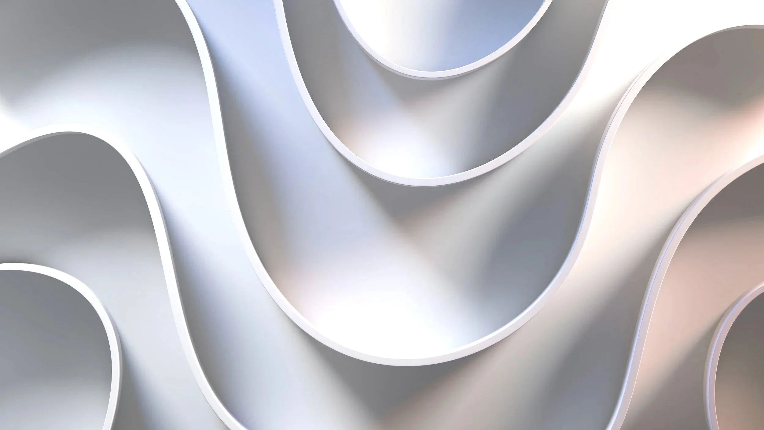 Close-up of a metallic structure with circular cutouts, creating a pattern of rounded, hollow tubes with smooth, reflective surfaces.