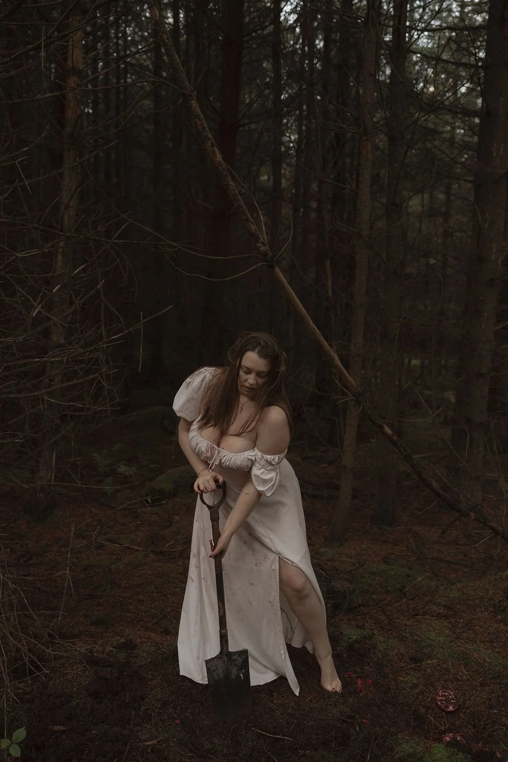 somatic coach - woman digging in woods